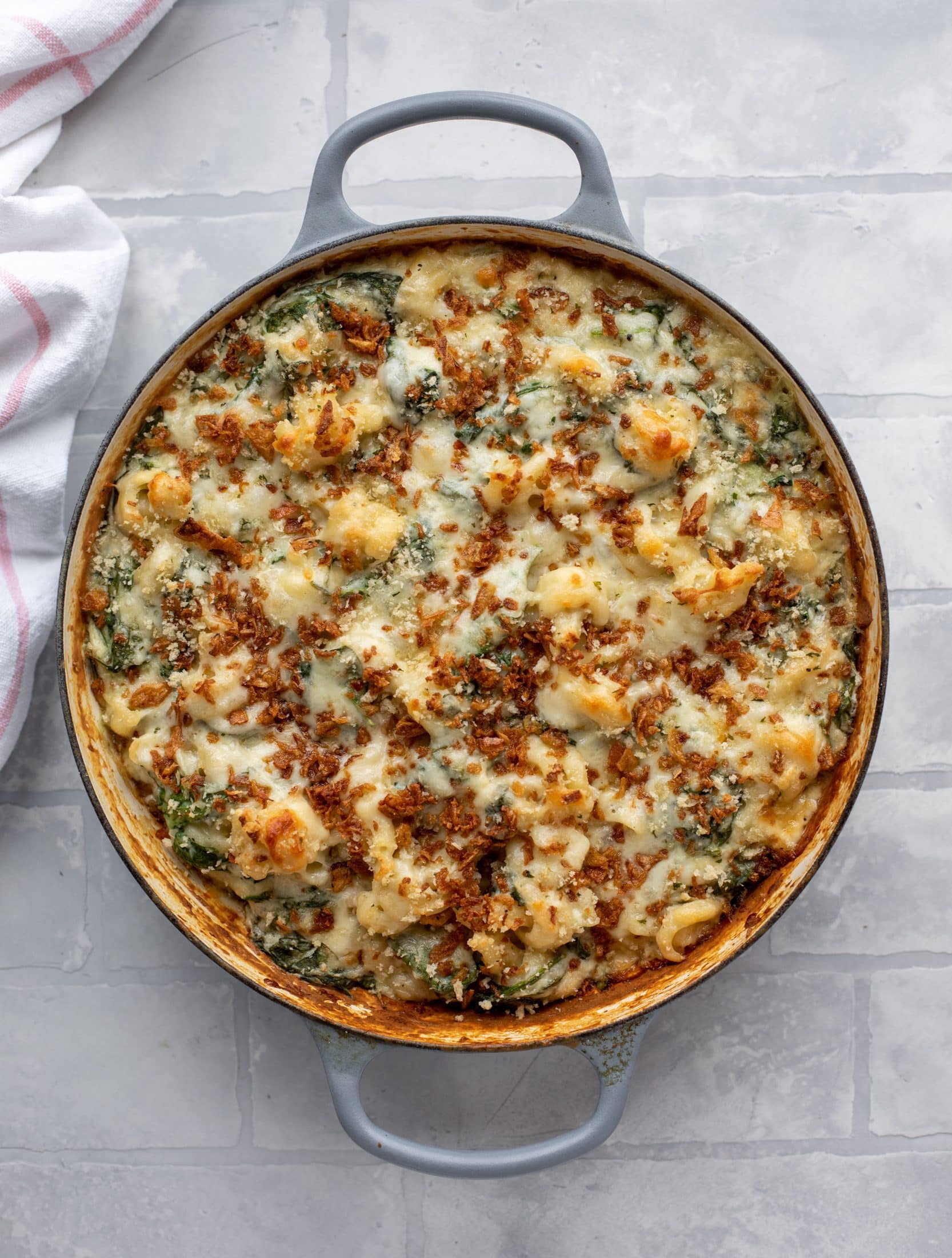 This creamed spinach mac and cheese is a dreamy, cheesy mac and cheese dish with tons of fresh baby spinach! Super comforting and flavorful. 