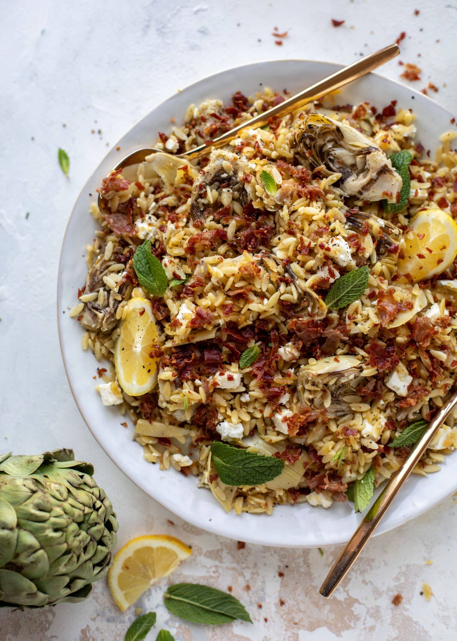 This crispy orzo is a wonderful spring dish. Artichoke hearts, lemon, goat cheese and herbs all topped with a sprinkling of crunchy prosciutto. 