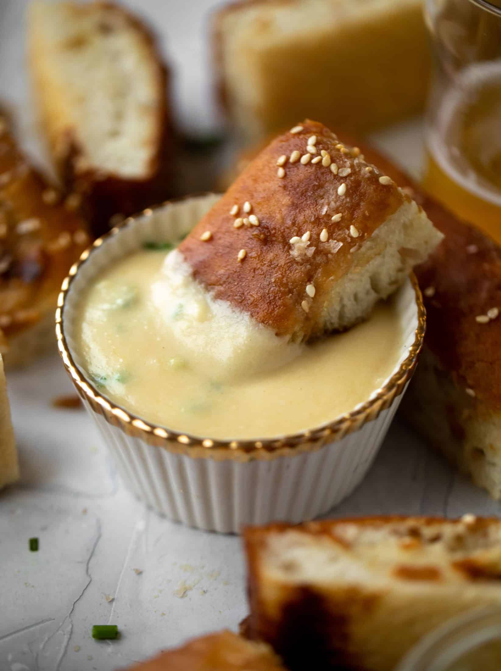 This sesame pretzel focaccia bread is amazing! Almost like a soft pretzel with crispy edges. Serve with a delicious dijon beer cheese.