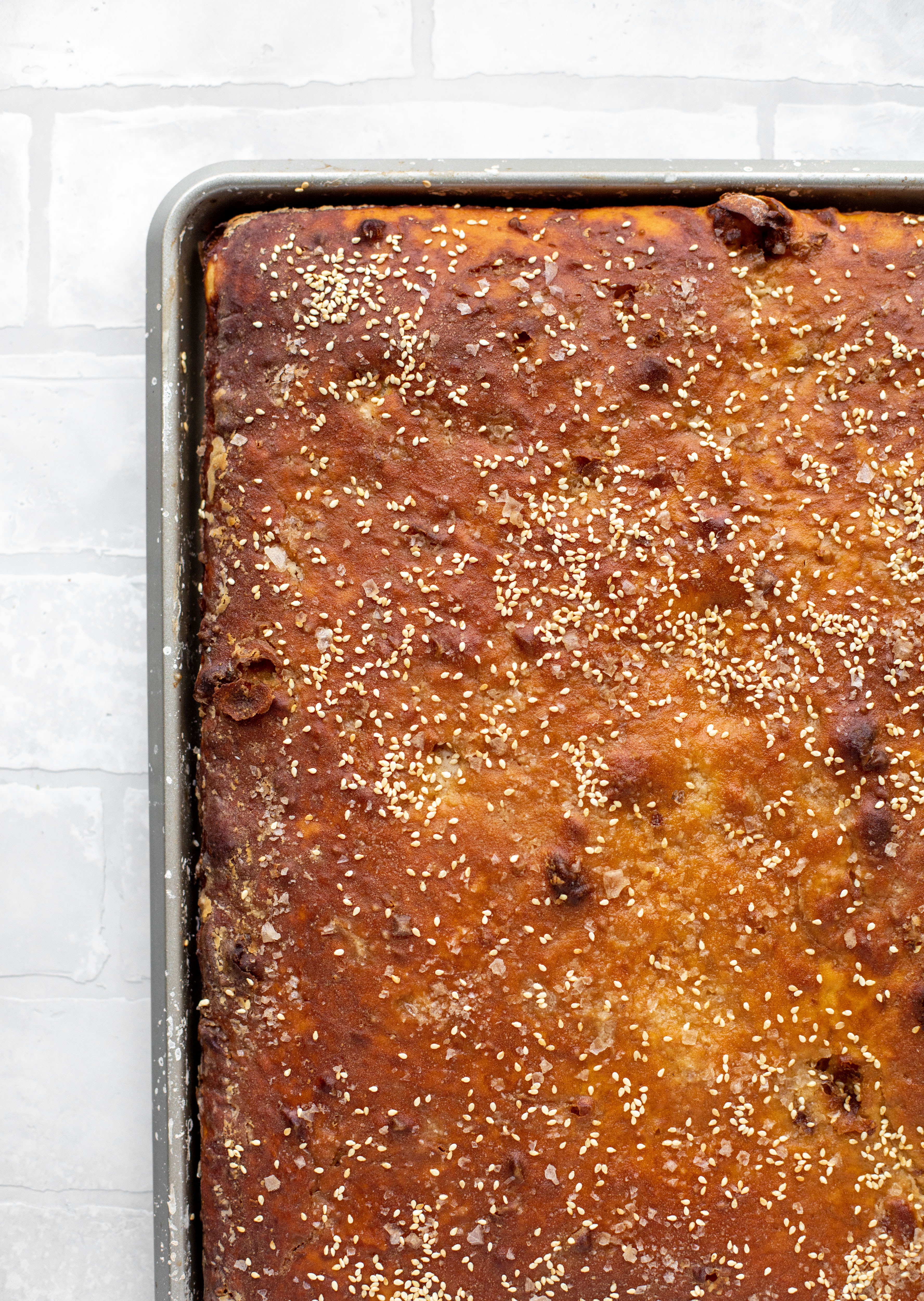 This sesame pretzel focaccia bread is amazing! Almost like a soft pretzel with crispy edges. Serve with a delicious dijon beer cheese.