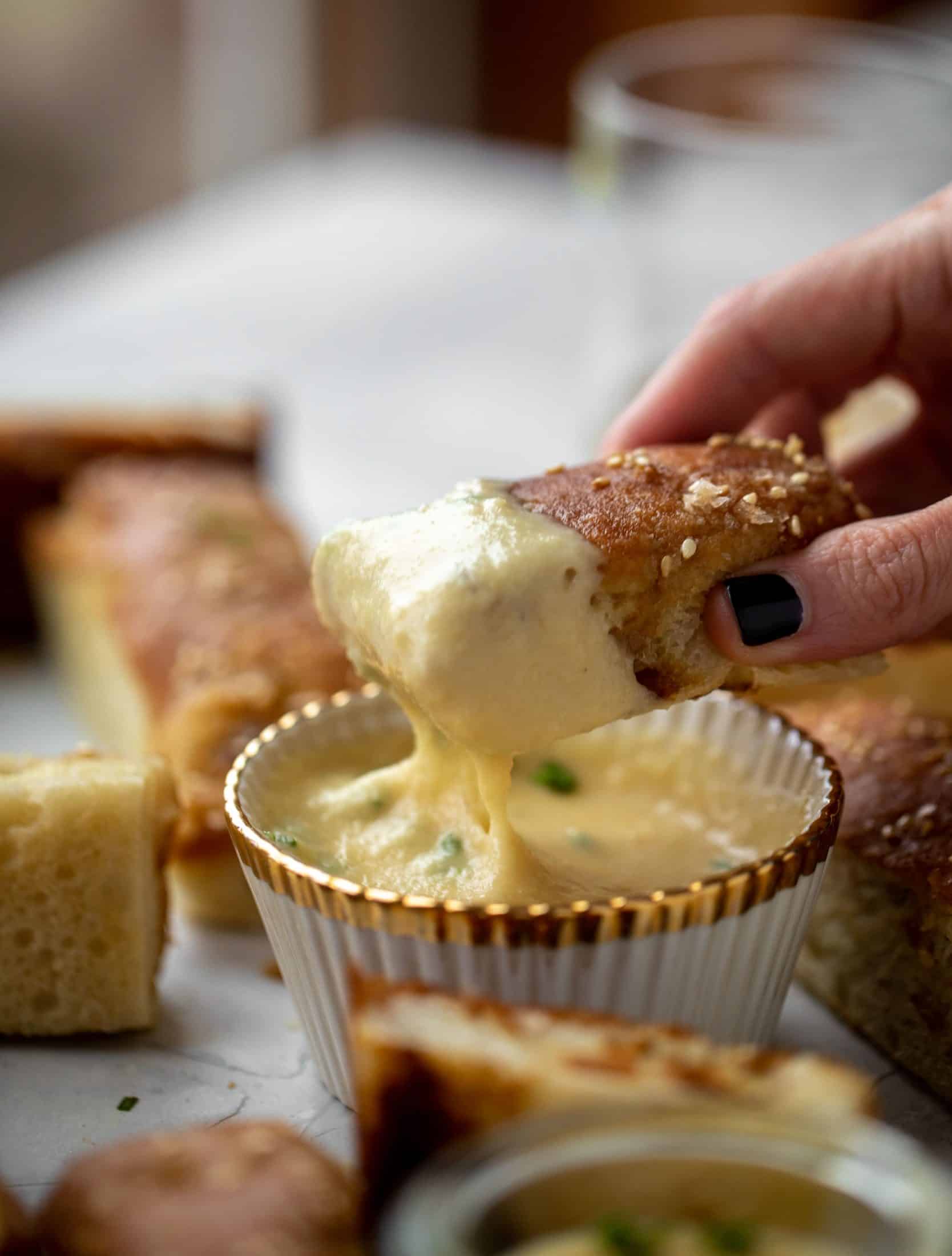 This sesame pretzel focaccia bread is amazing! Almost like a soft pretzel with crispy edges. Serve with a delicious dijon beer cheese.