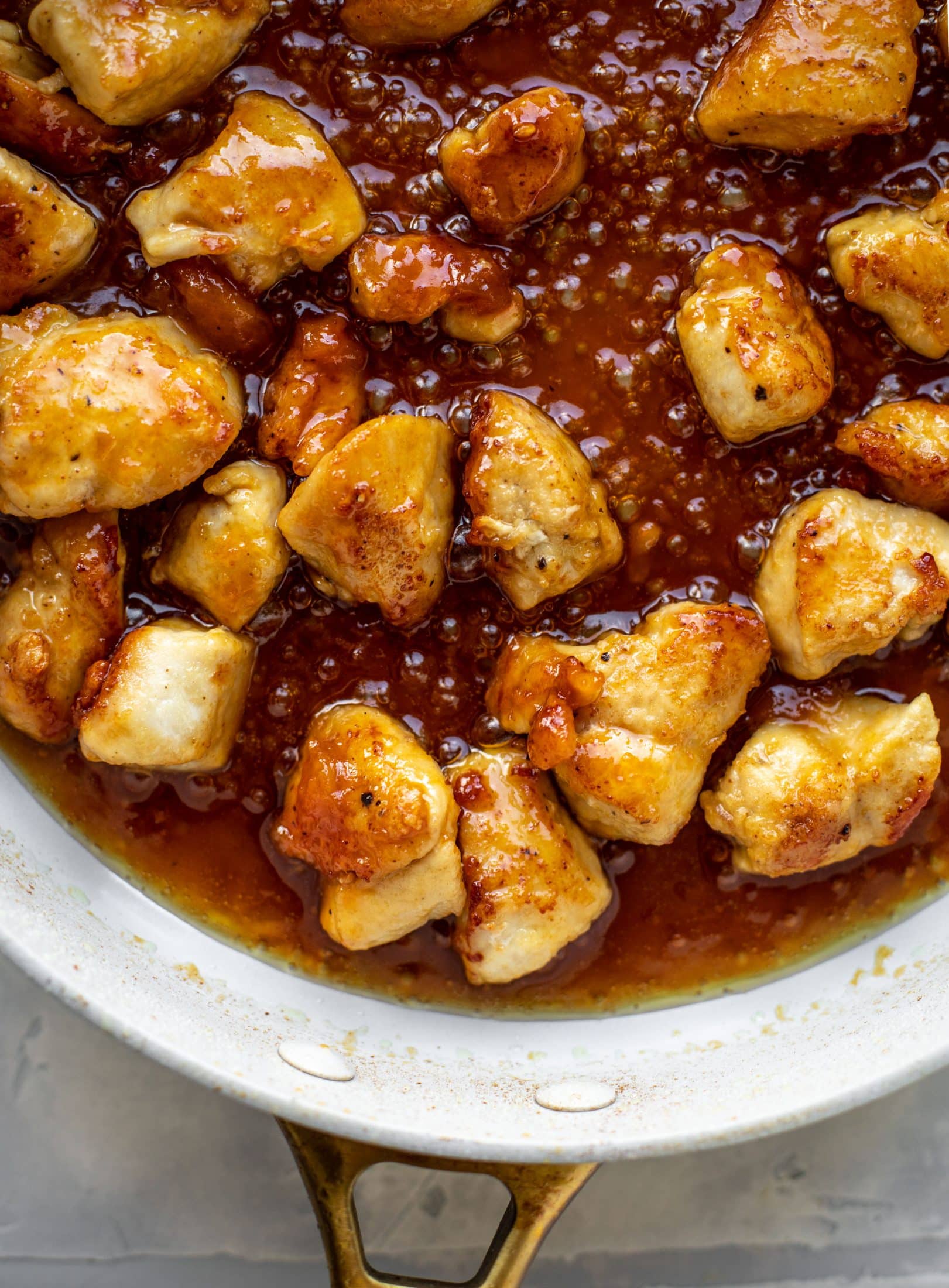 This sticky apricot chicken is so juicy and delicious! The chicken is seared and glazed with a jammy apricot sauce. Serve with broccoli and rice!
