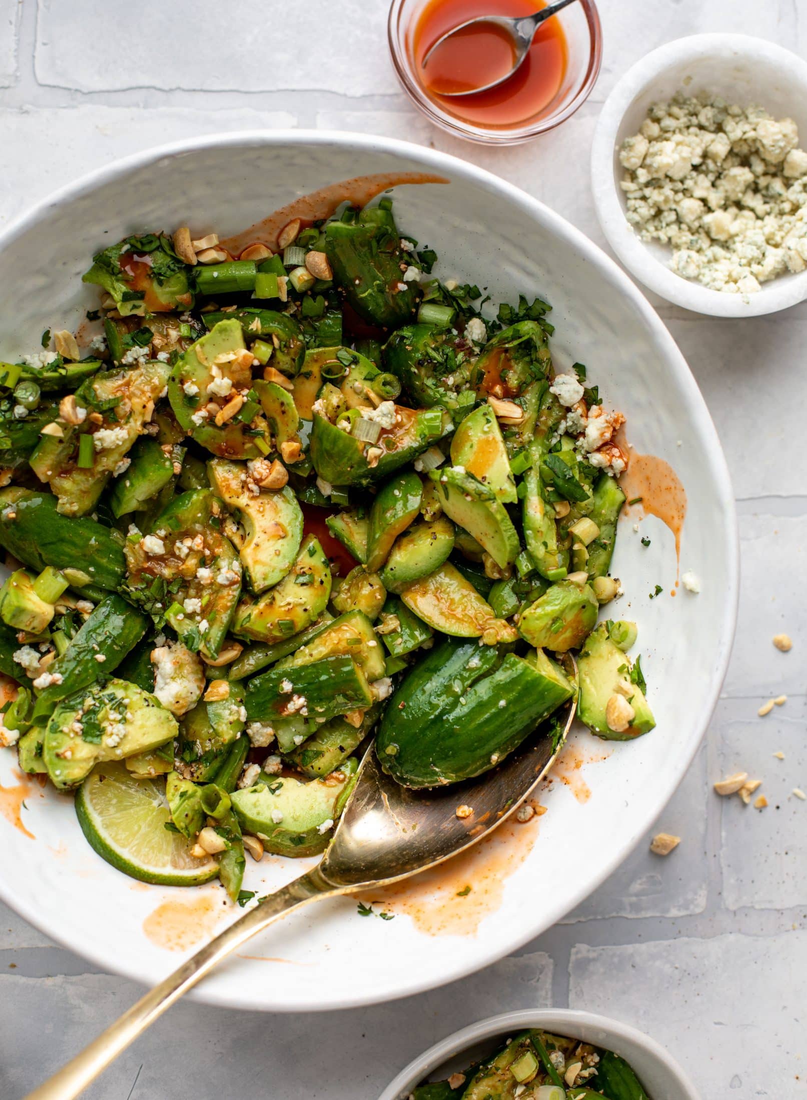 This smashed buffalo cucumber salad is filled with tons of buffalo wing flavor! Avocado, blue cheese, peanuts and lime juice make this irresistible. 
