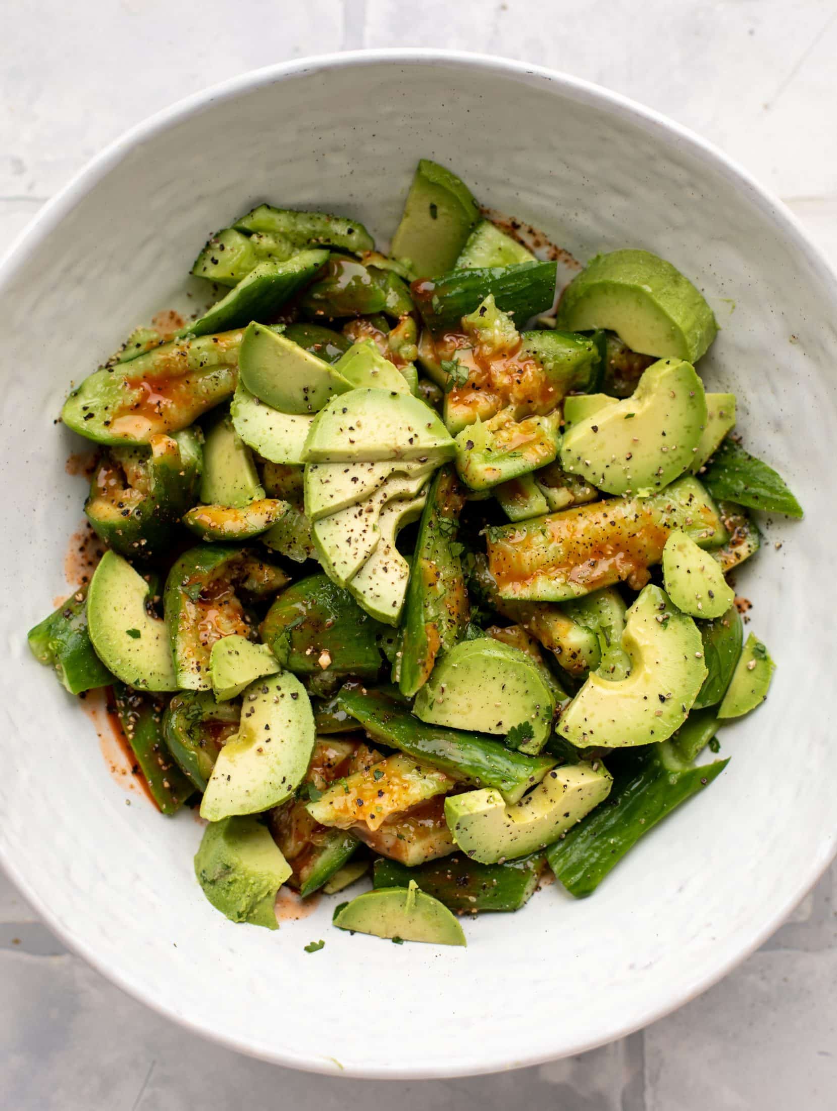 This smashed buffalo cucumber salad is filled with tons of buffalo wing flavor! Avocado, blue cheese, peanuts and lime juice make this irresistible. 