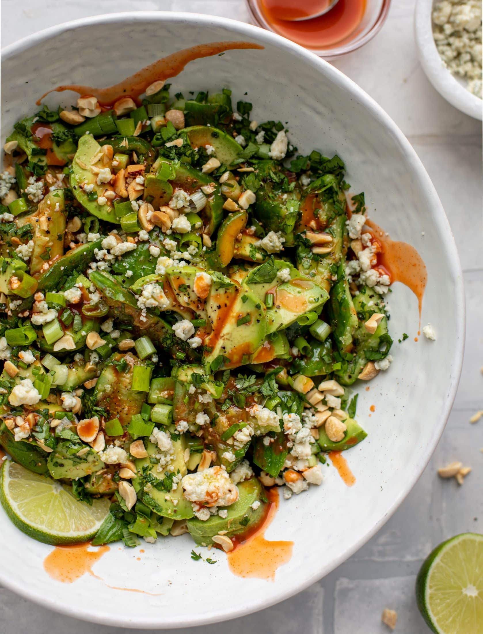 This smashed buffalo cucumber salad is filled with tons of buffalo wing flavor! Avocado, blue cheese, peanuts and lime juice make this irresistible. 
