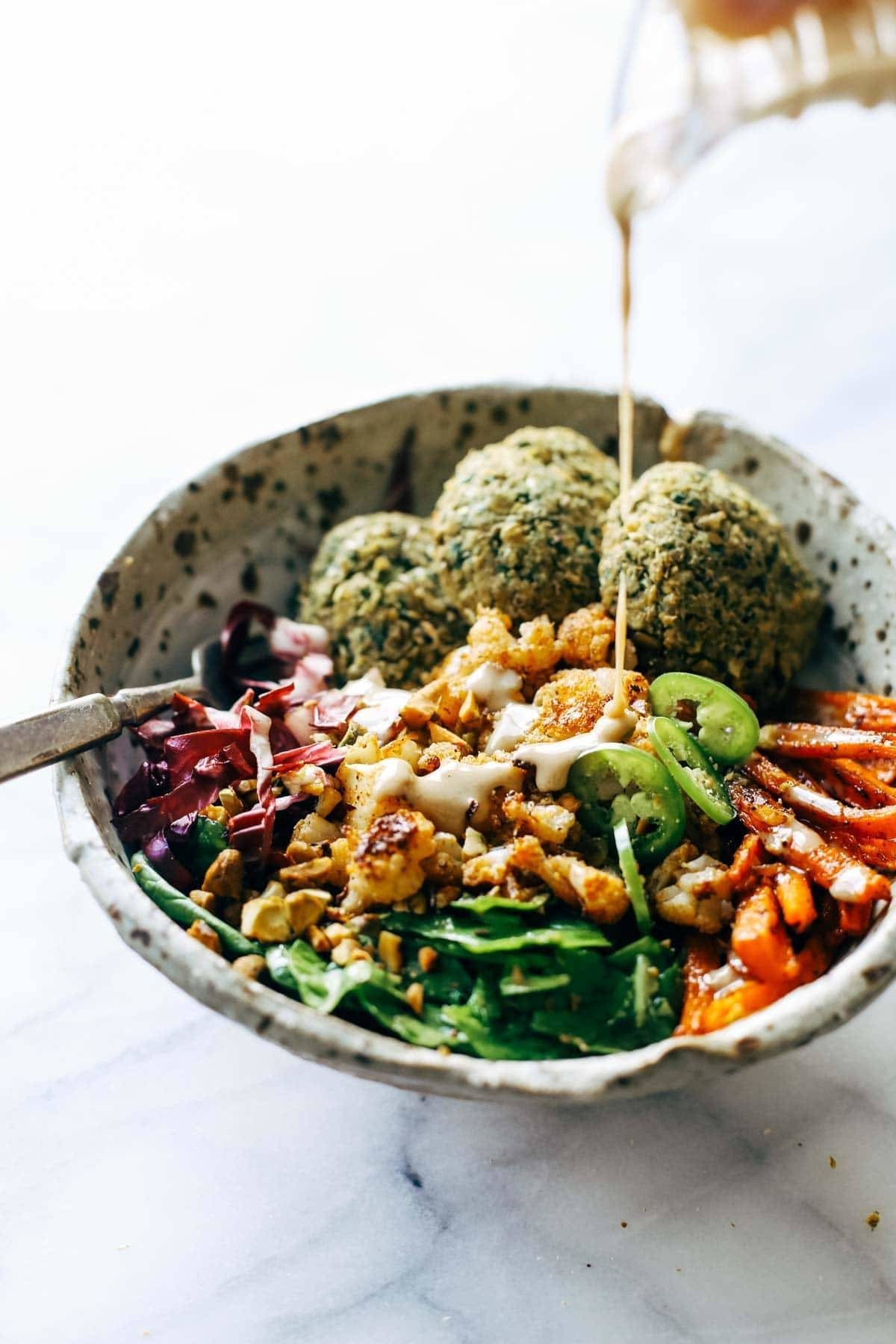Keep your glow all winter! Easy homemade falafel, roasted veggies, and flavorful sauce all in one big bliss bowl! vegetarian / vegan / gluten free recipe. | pinchofyum.com Keep your glow all winter! Easy homemade falafel, roasted veggies, and flavorful sauce all in one big bliss bowl! vegetarian / vegan / gluten free recipe. | pinchofyum.com