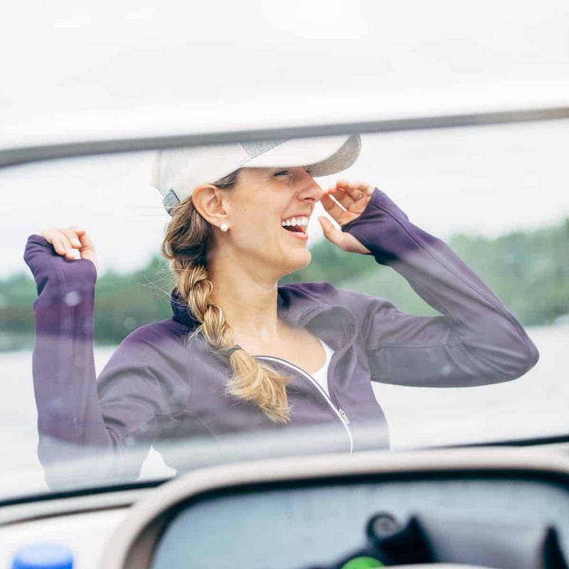 Lindsay laughing on a speed boat.