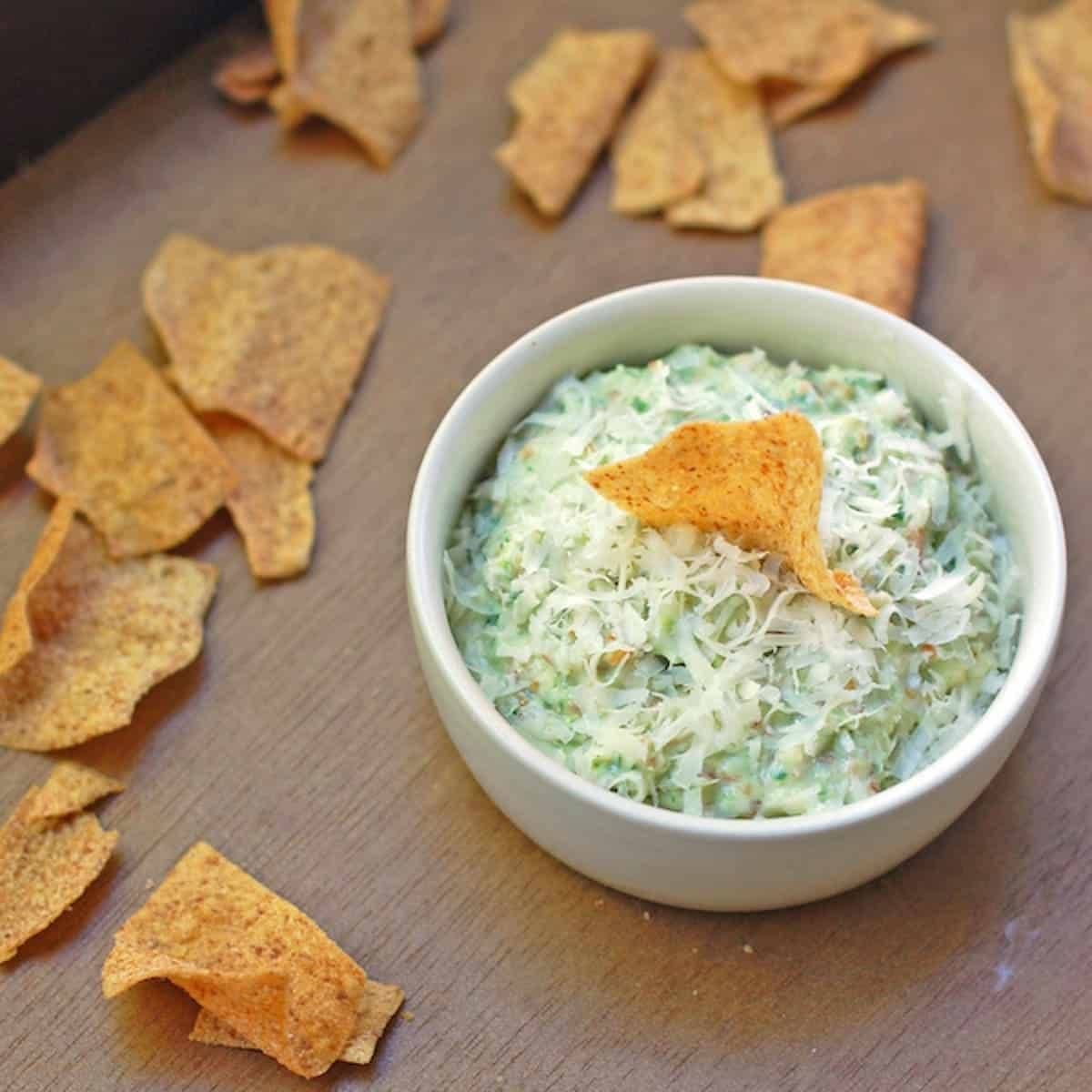 Creamy garlic scape dip with chips.