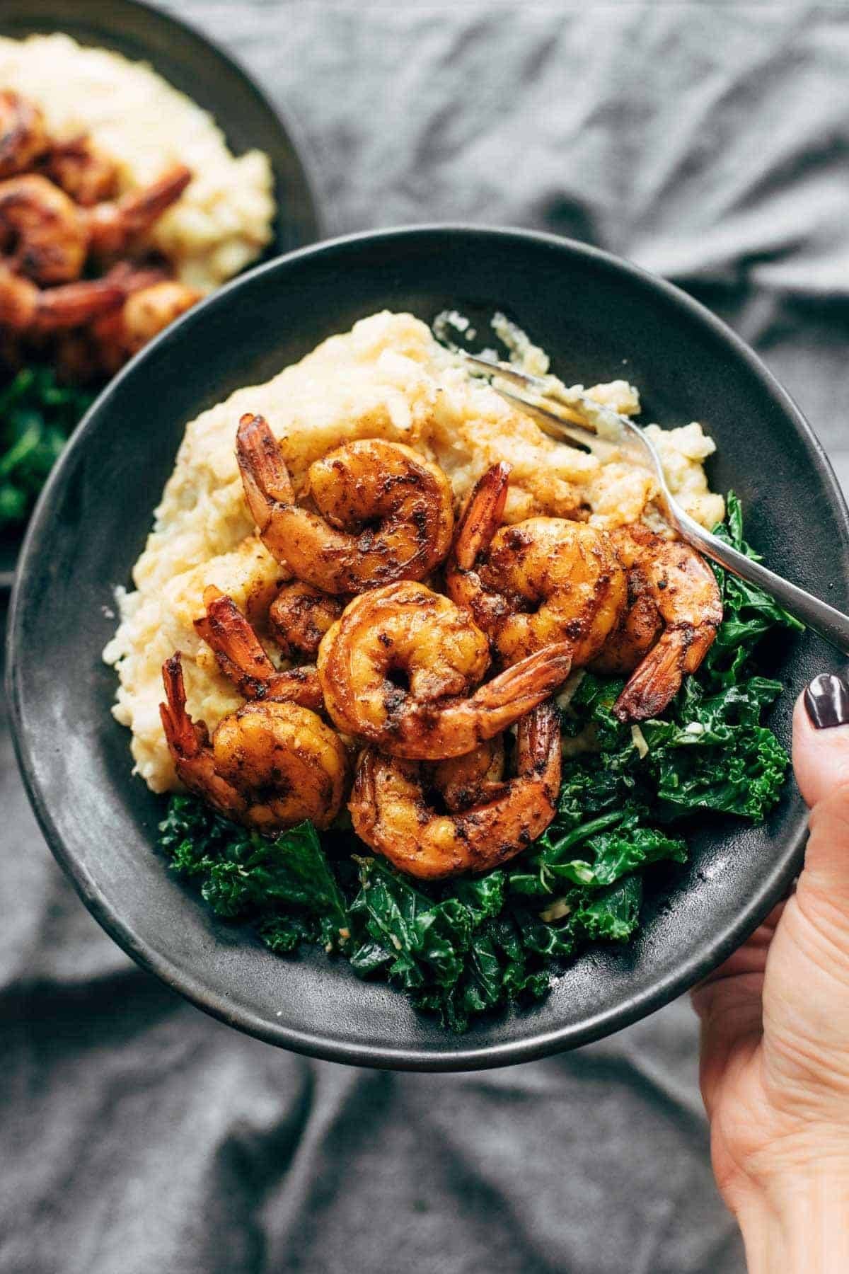 Spicy shrimp on top of cauliflower mash and kale.