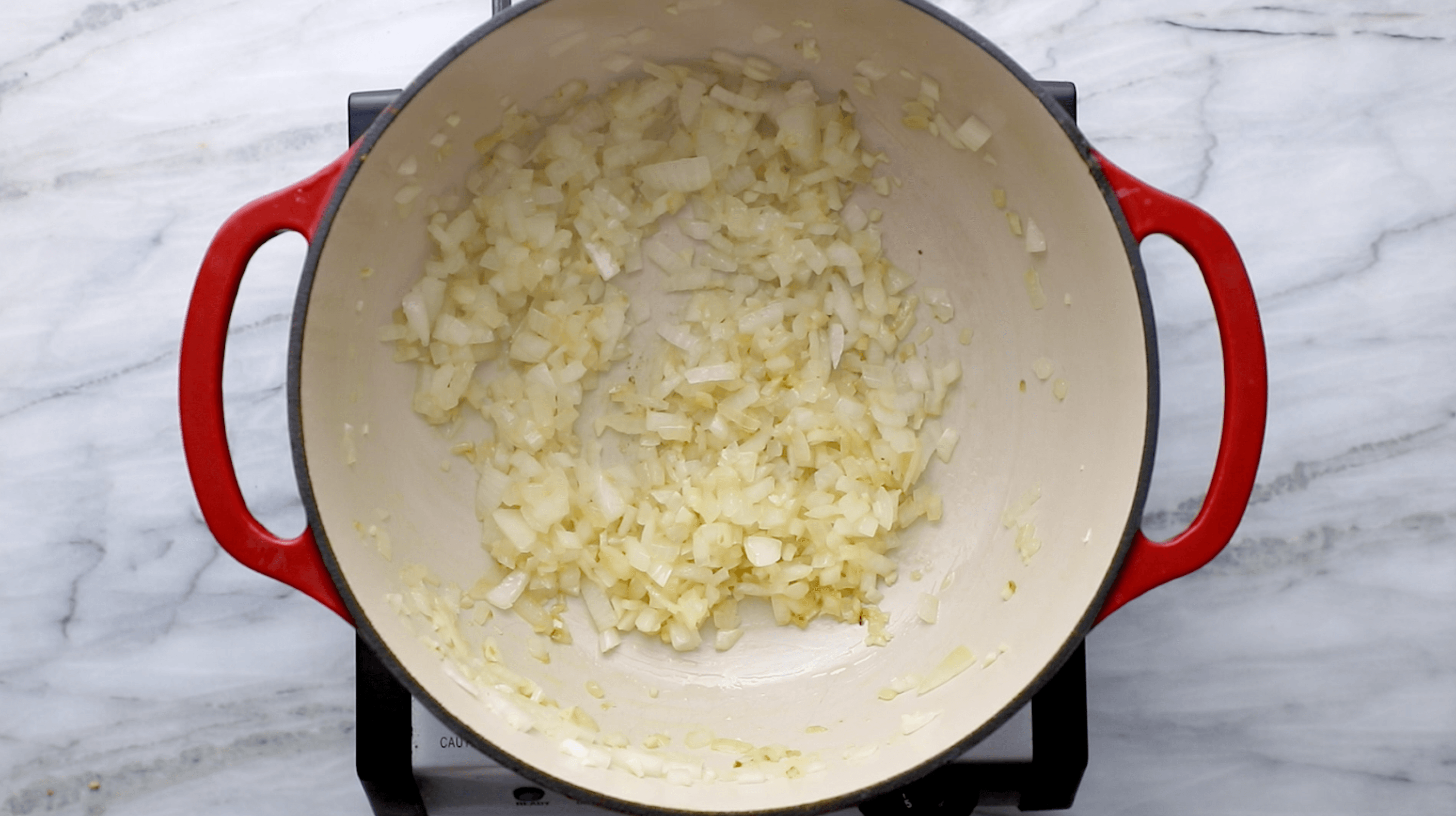 Onion and garlic in a dutch oven.