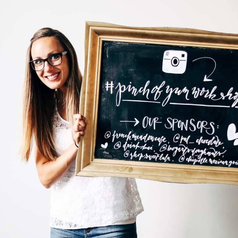 Lindsay holding a chalkboard for the Tasty Food Photography workshop.