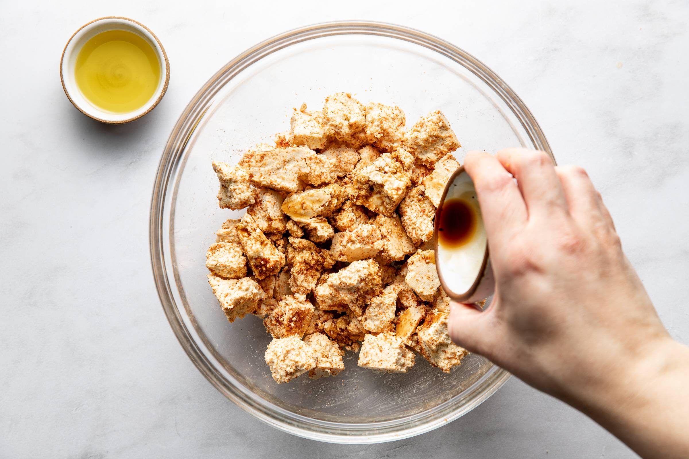 Coating tofu in soy sauce.