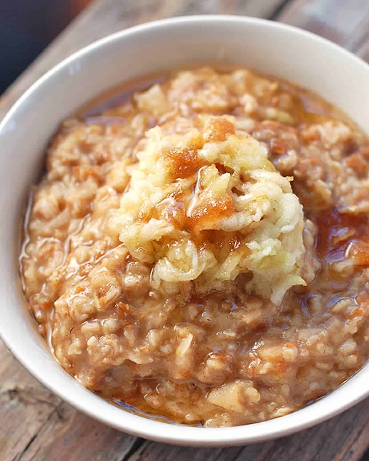 Brown sugar apple bran oatmeal in a white bowl.