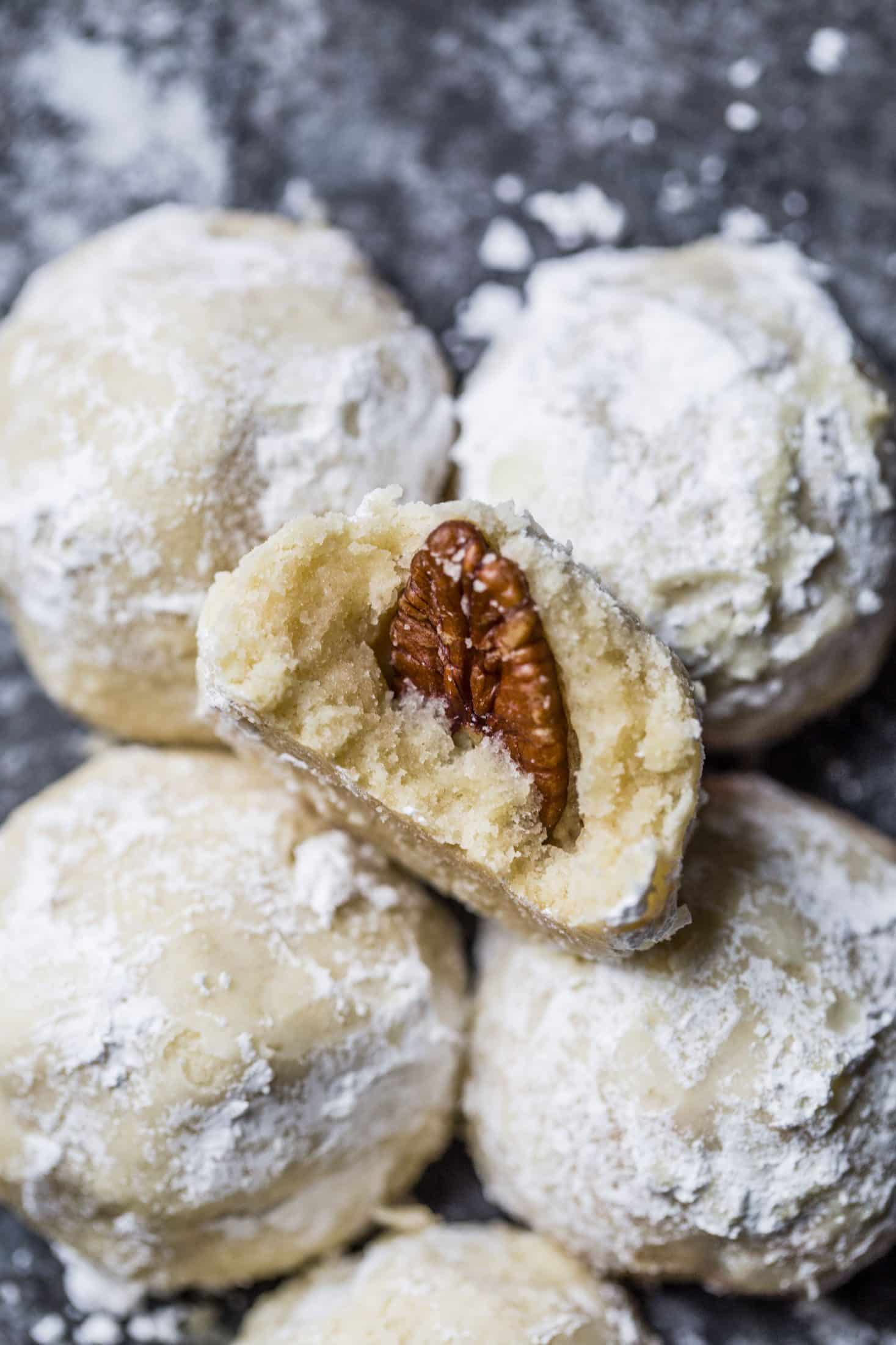 These classic butterball cookies are a favorite that my grandmother made every year at Christmas. They are a light cookie that isn't super sweet and the center is filled with either a pecan or maraschino cherry. Classic and delicious! I howsweeteats.com #butterball #cookies