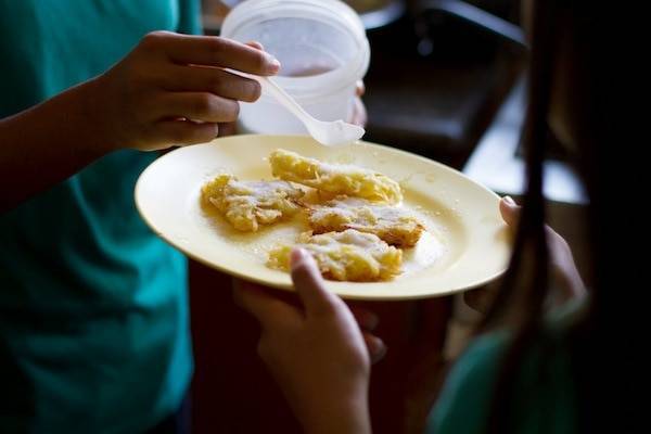 Sugary camote fritters on a yellow plate.