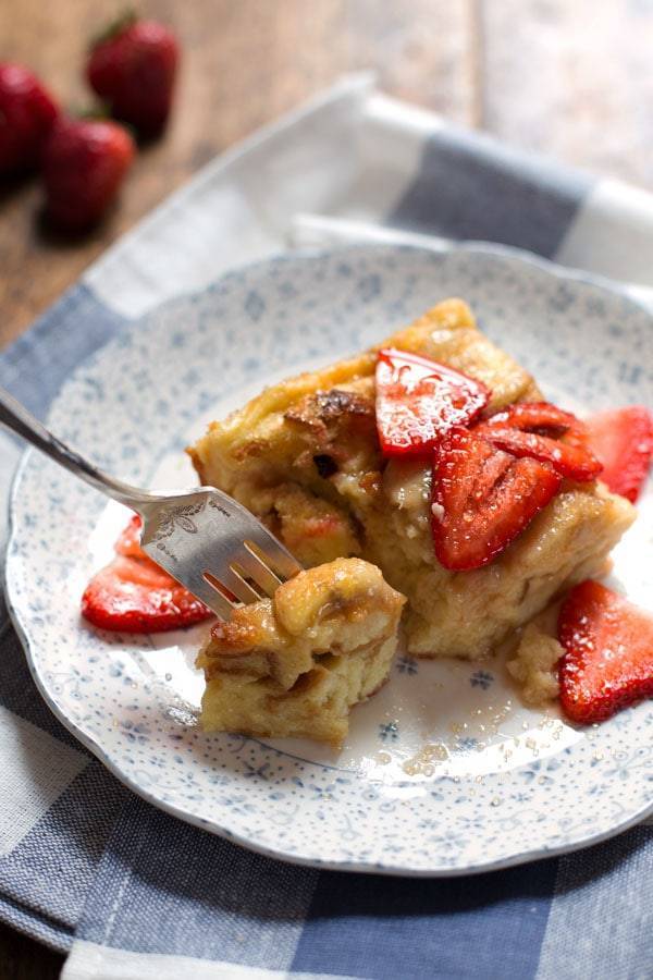 Coconut French Toast Bake with strawberries on a plate.