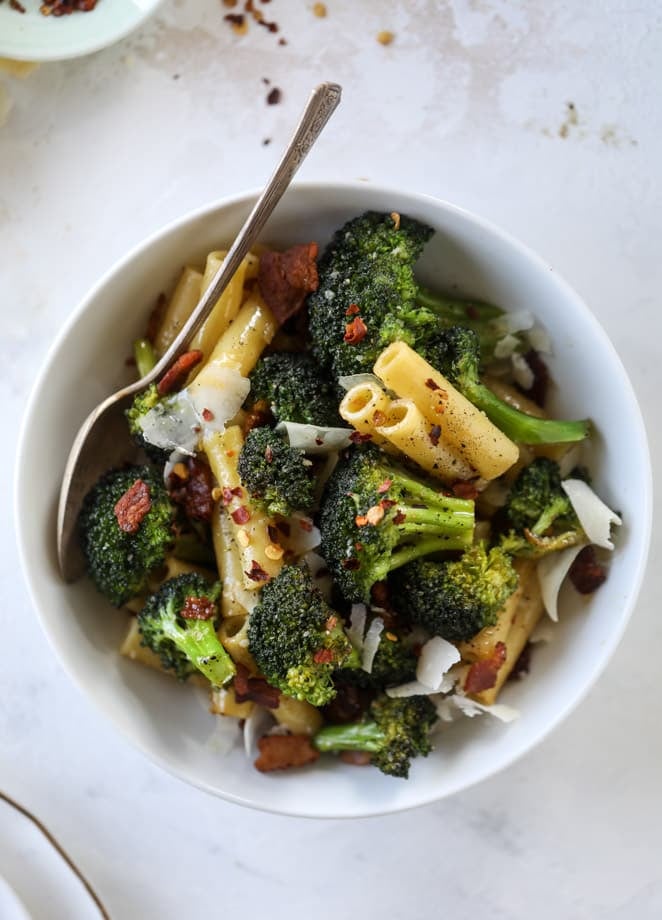 This is the easiest weeknight bacon broccoli pasta that can come together in minutes! Super flavorful and filled with crispy bacon, fresh broccoli, shaved parmesan and crushed red pepper, it's delicious on its own or as a base for more veggies or meat! I howsweeteats.com #bacon #broccoli #pasta #easy #dinner #recipes