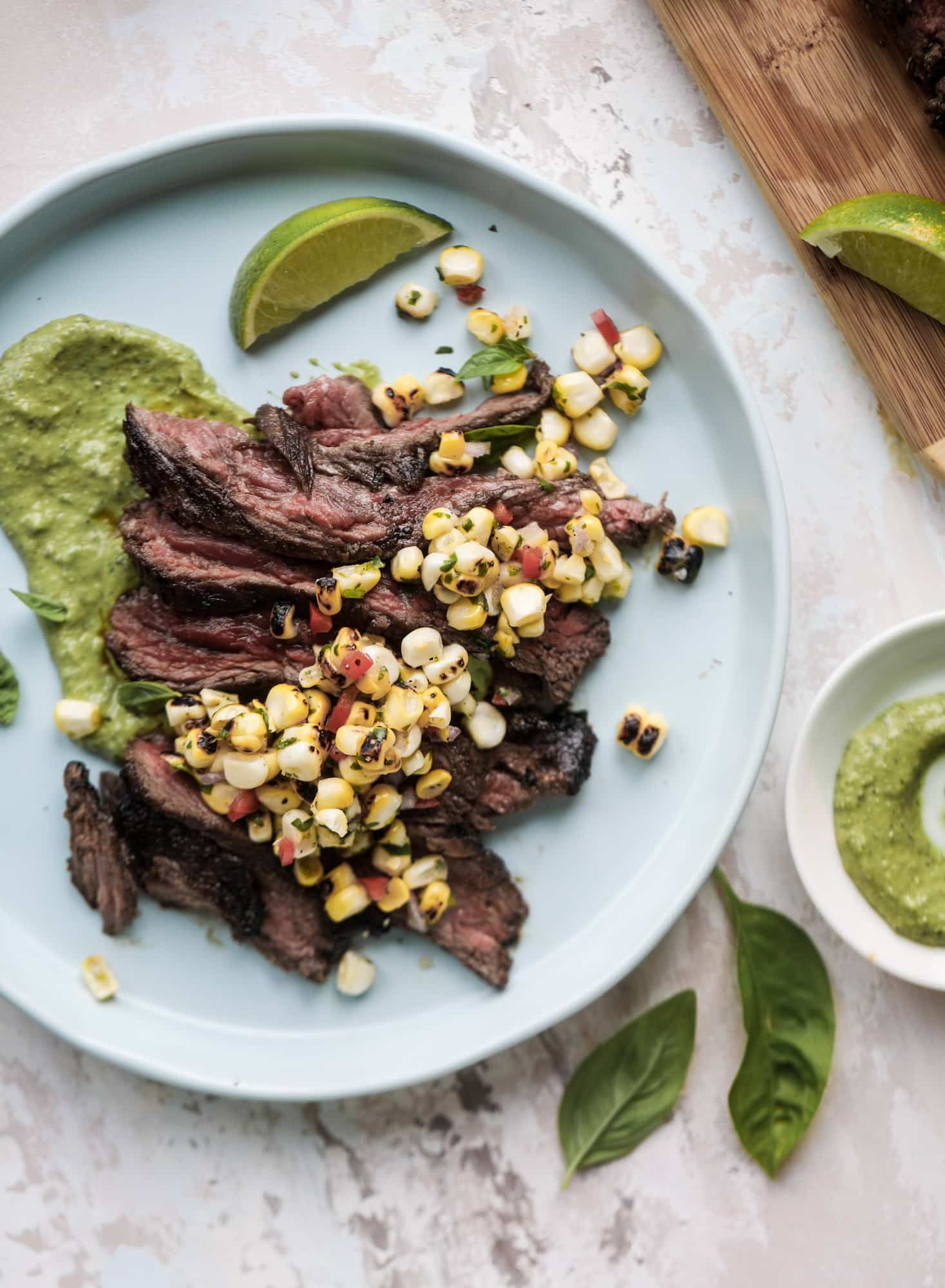 This skirt steak recipe is so super easy and delicious! Marinate it for a bit, prepare it to your liking then serve it with the most flavorful avocado pesto and grilled corn relish. Feels like a fancy restaurant meal and will make you love skirt steak forever! I howsweeteats.com #skirt #steak #avocado #pesto #corn #relish #recipes