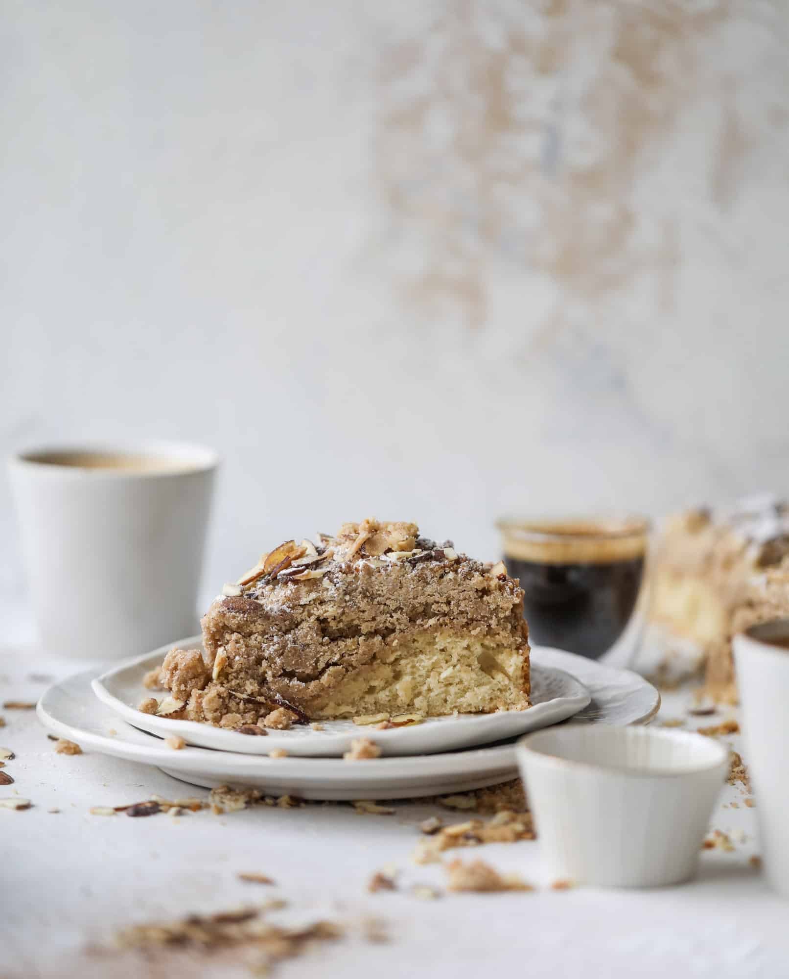 This almond crumb cake is so delicious and perfect for breakfast or dessert! It's full of delicious almond flavor and crunch and the crumb on top is so thick and perfect. It's like an almond croissant on steroids. I howsweeteats.com #almond #crumb #cake
