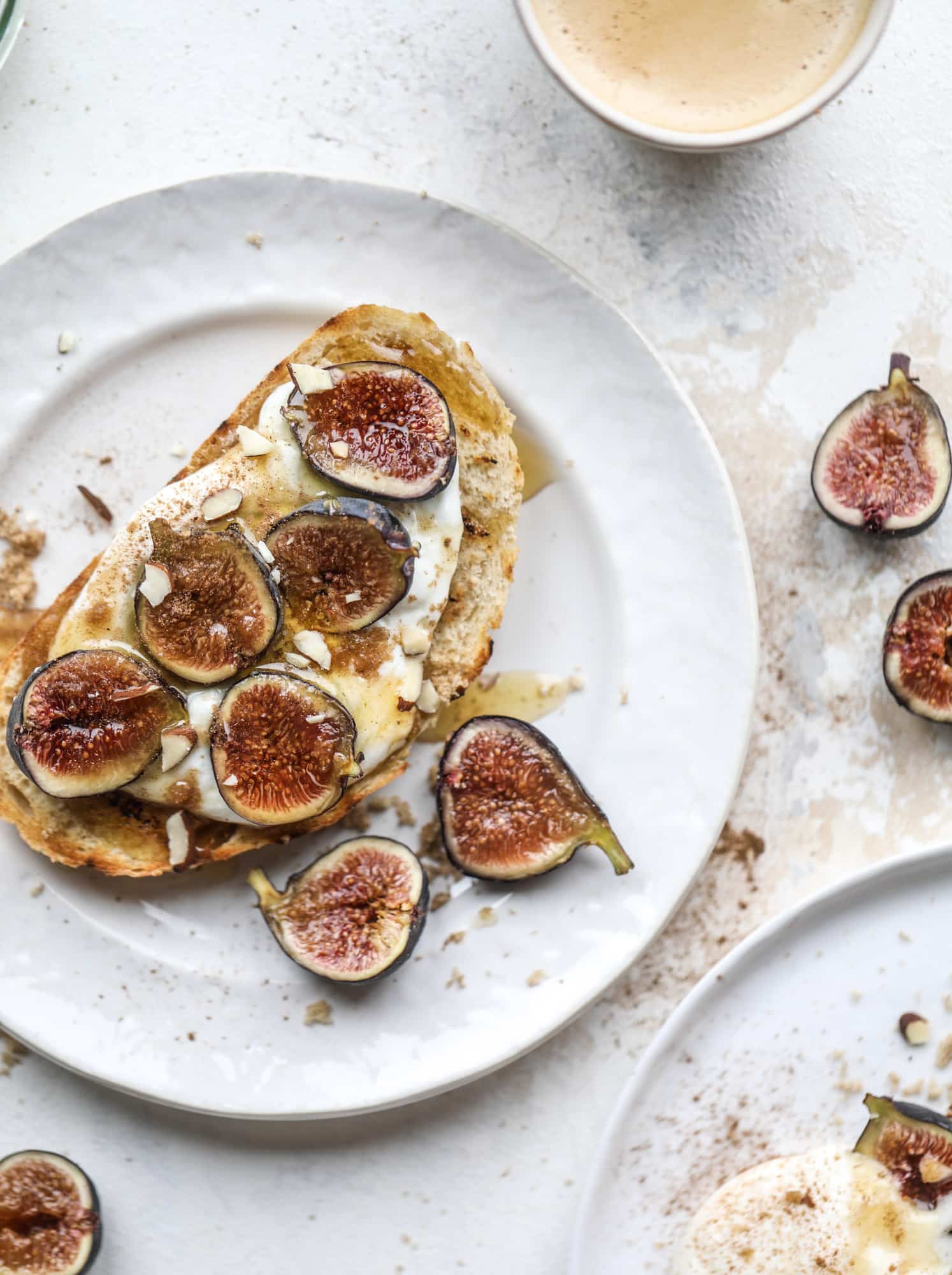 This cinnamon sugar toast is an absolutely dream! It's spread with a cinnamon brown sugar butter, grilled to perfection and served with creamy whipped ricotta cheese, fresh figs, honey, cinnamon and sliced almonds. I howsweeteats.com #cinnamon #sugar #toast #ricotta #figs #breakfast