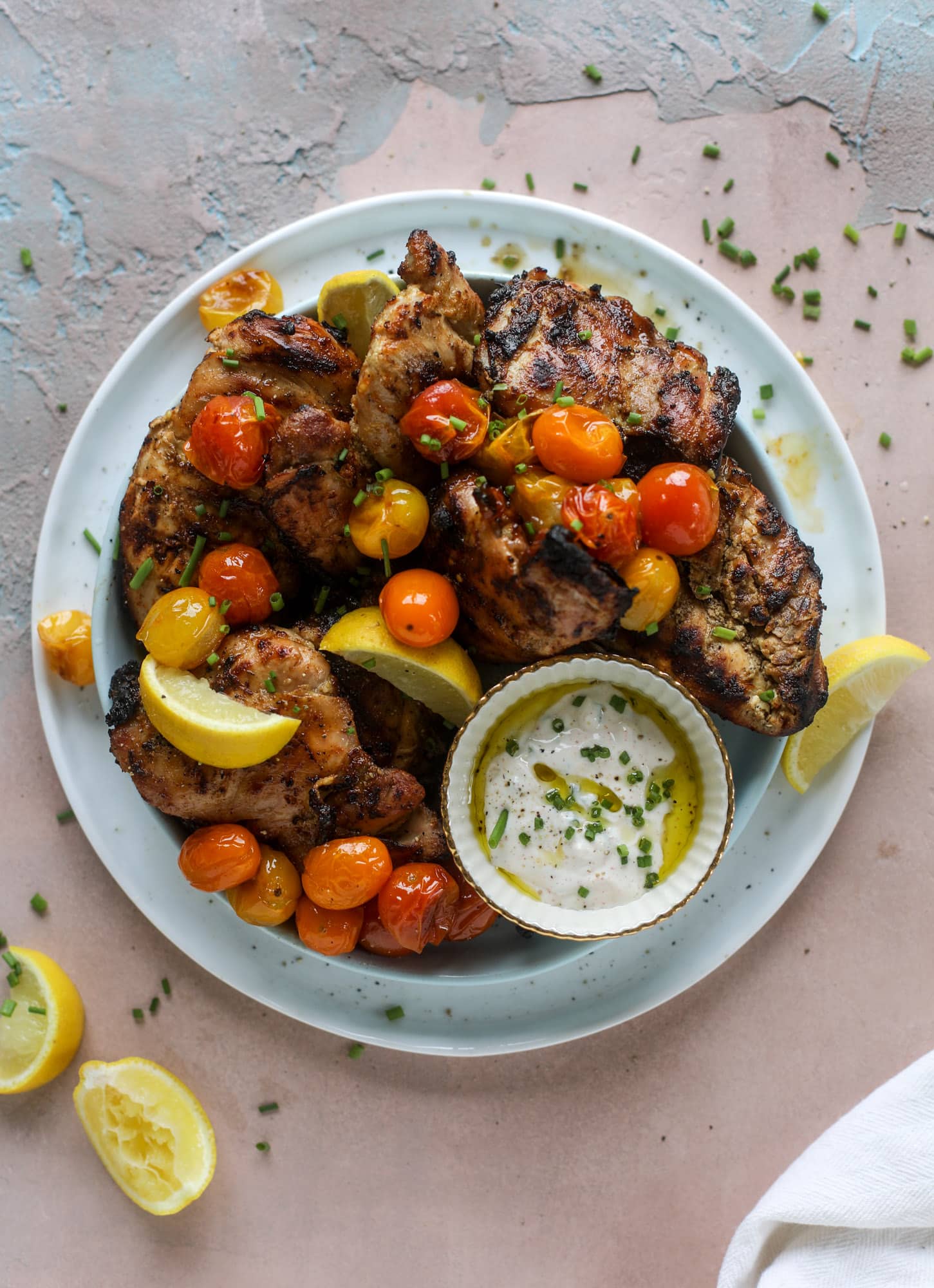 This yogurt marinated chicken recipe is super flavorful, tender, juicy and delicious. The fresh lemon adds a kick of flavor and it's a versatile recipe you can make for lunch or dinner. Grill it and serve with your favorite side, then use the leftovers for lunch! I howsweeteats.com #yogurt #chicken #lemon #grilled #healthy #recipes