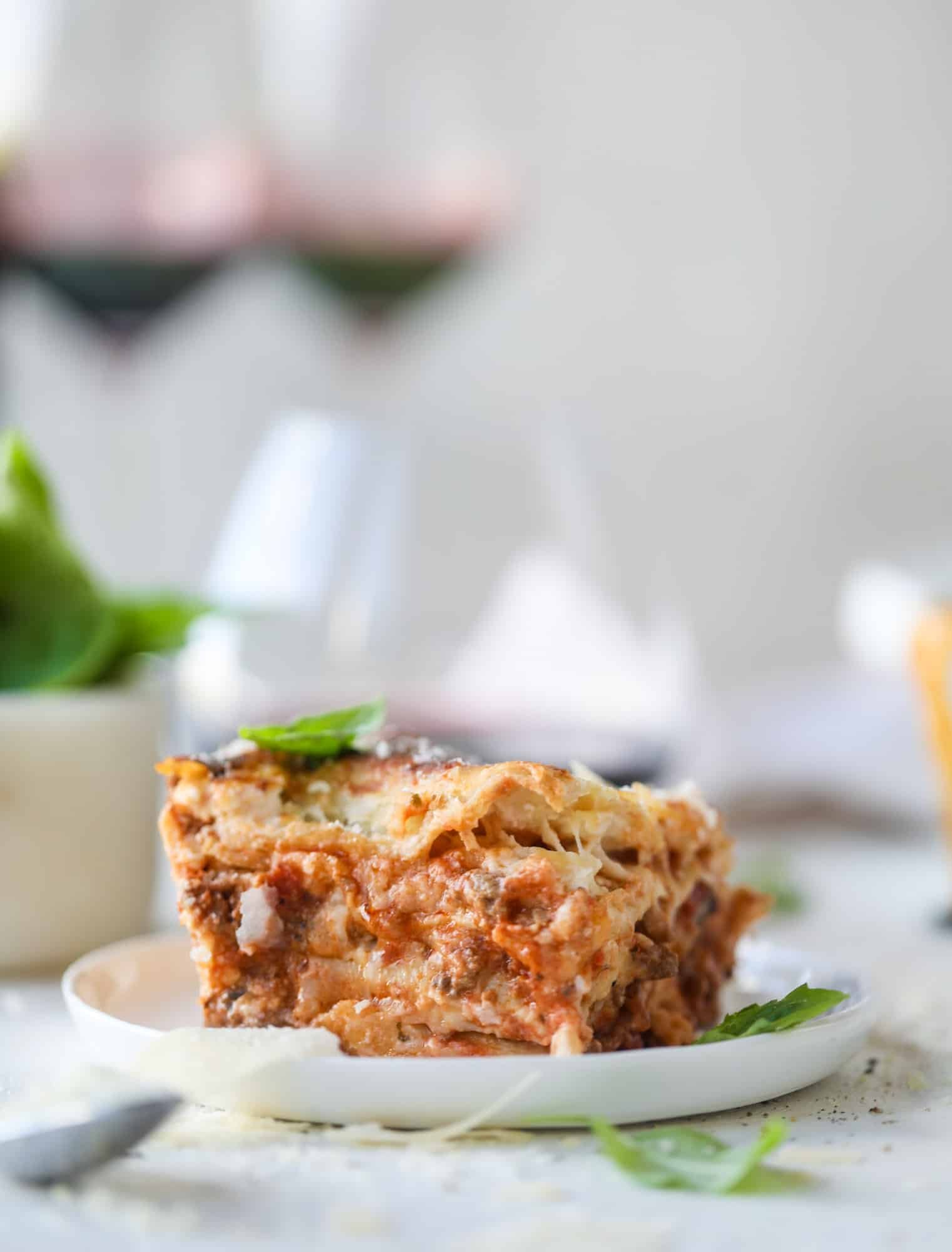 This lasagna bolognese is the ultimate comfort food. Meaty sauce, whole wheat lasagna noodles, creamy bechamel and grated cheese come together to create the most perfect slice of lasagna heaven! I howsweeteats.com #lasagna #bolognese