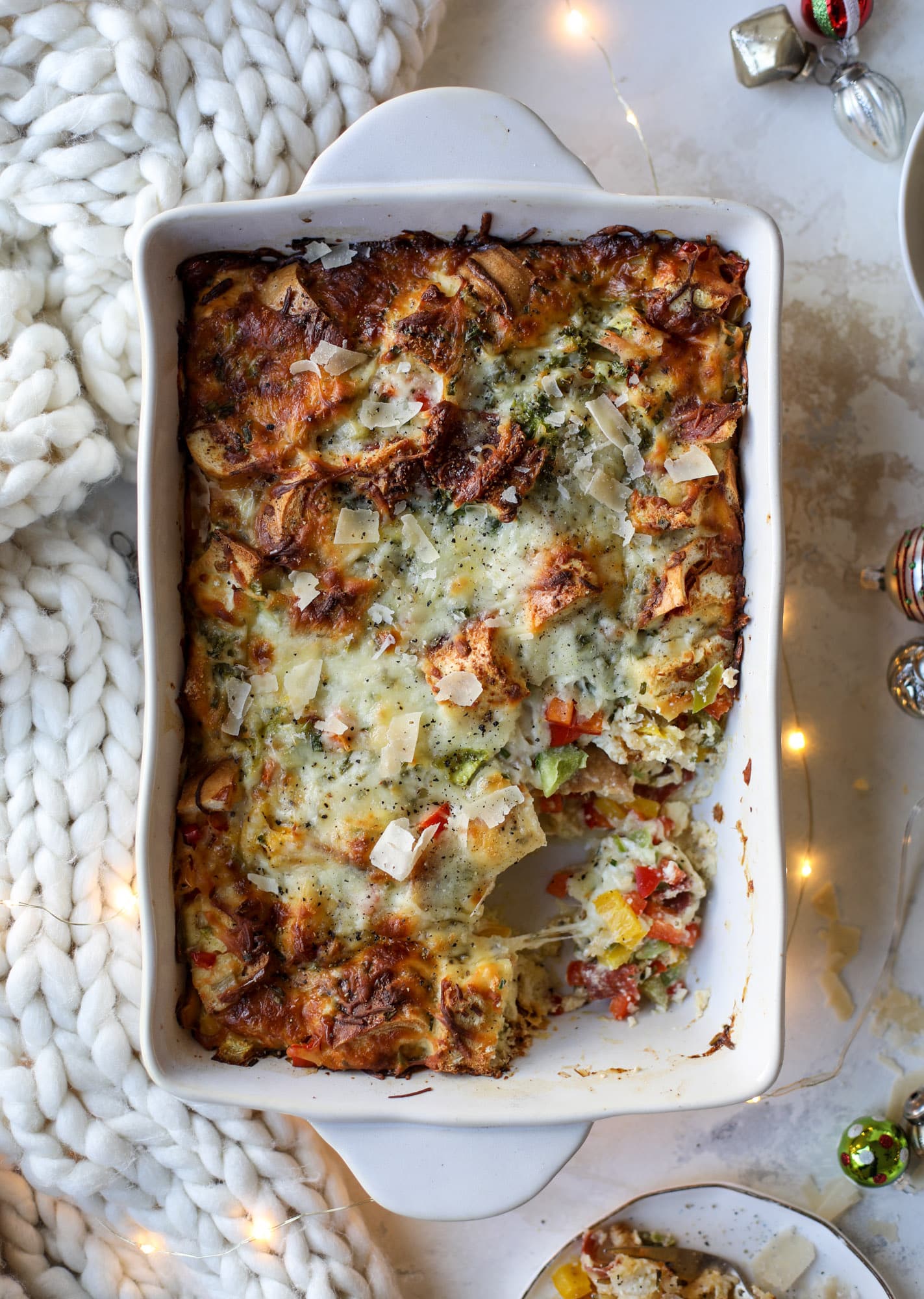 This breakfast strata is super special because the base is built on pepperoni rolls! This make ahead casserole is perfect for holiday brunches or parties and tastes like a supreme pizza. It's so easy to throw together too! I howsweeteats.com #breakfast #strata