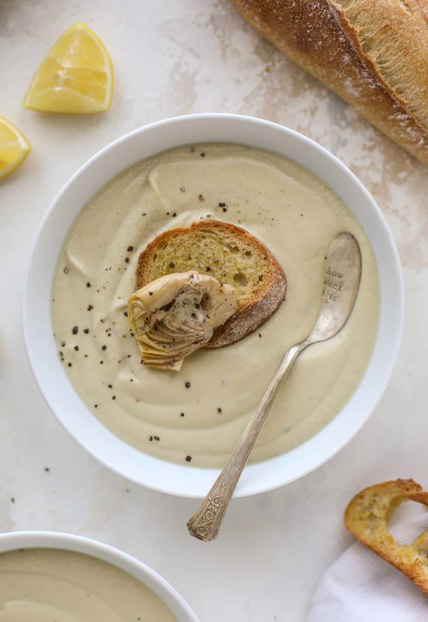  This creamy artichoke soup is full of artichoke hearts, cream and crème fraiche. It's rich and hearty but also light in flavor - perfect for late winter. I howsweeteats.com #artichoke #soup