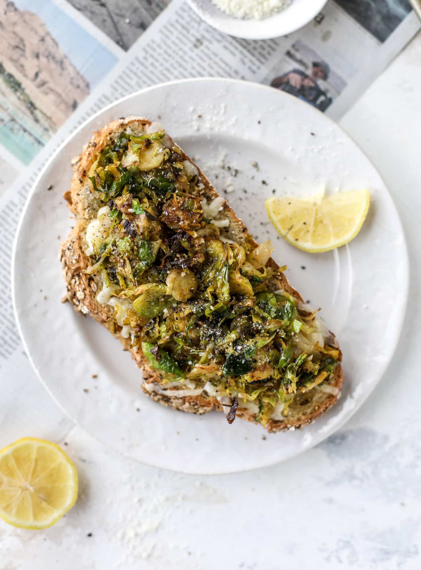 Crispy brussels sprouts toast begins with sourdough bread, melty havarti cheese and caramelized onions. It's high-maintenance toast in the best way possible. I howsweeteats.com