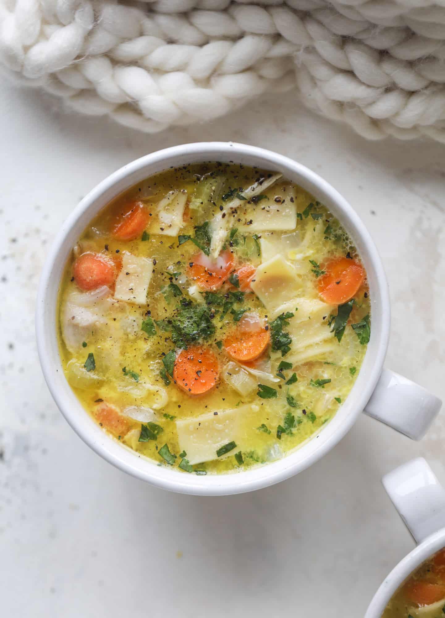This chicken noodle egg drop soup is the ultimate comfort food! Homemade stock and satisfying ingredients provide the best nourishment and comfort! I howsweeteats.com #chicken #noodlesoup