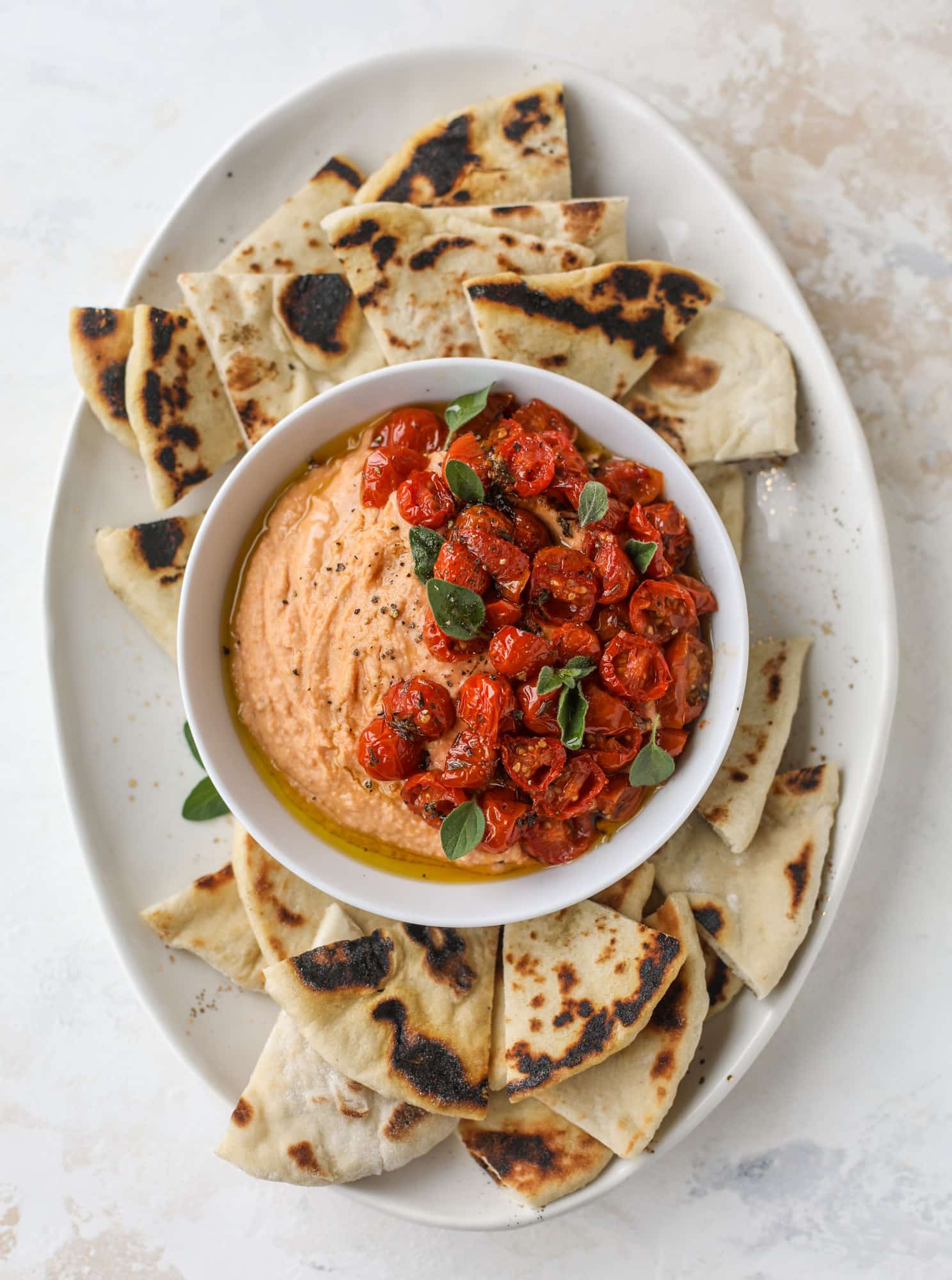 Slow roasted tomato hummus is a creamy and savory spread that is perfect for dipping, sandwiches or wraps, salads and bowls of all kind! I howsweeteats.com #slowroastedtomato #hummus