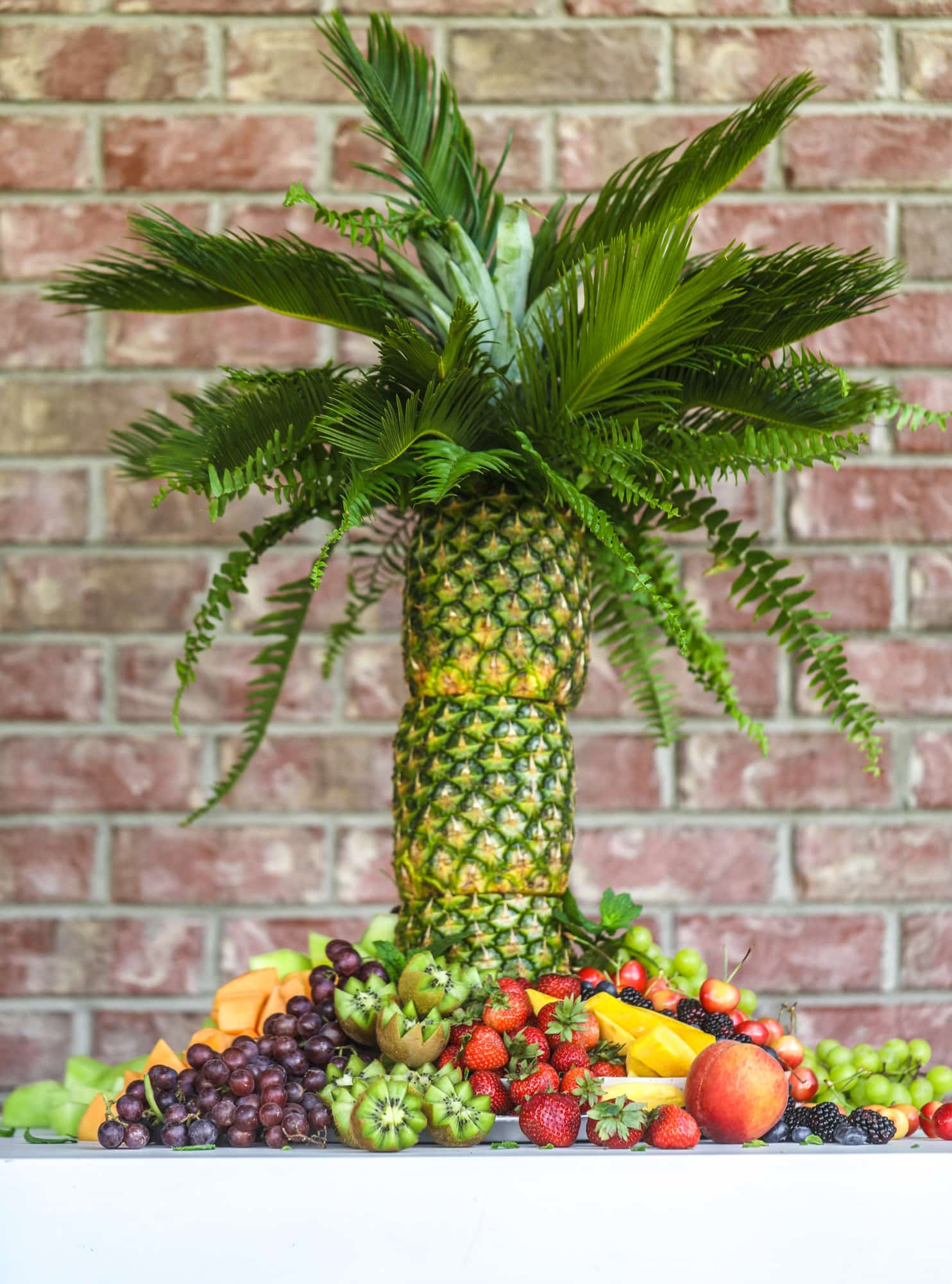 This is the cutest way to display fruit! A pineapple palm tree fruit tray will be the star of the show at your next summer BBQ or party! 
