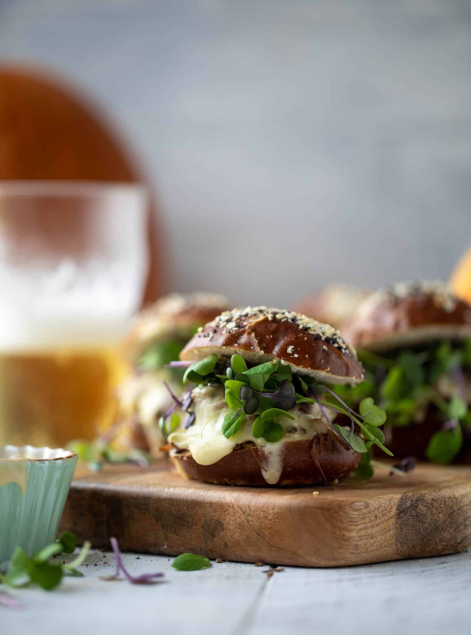 This pumpkin beer brisket melts are smothered in havarti cheese and served on everything pretzel rolls. They are ridiculously delicious!