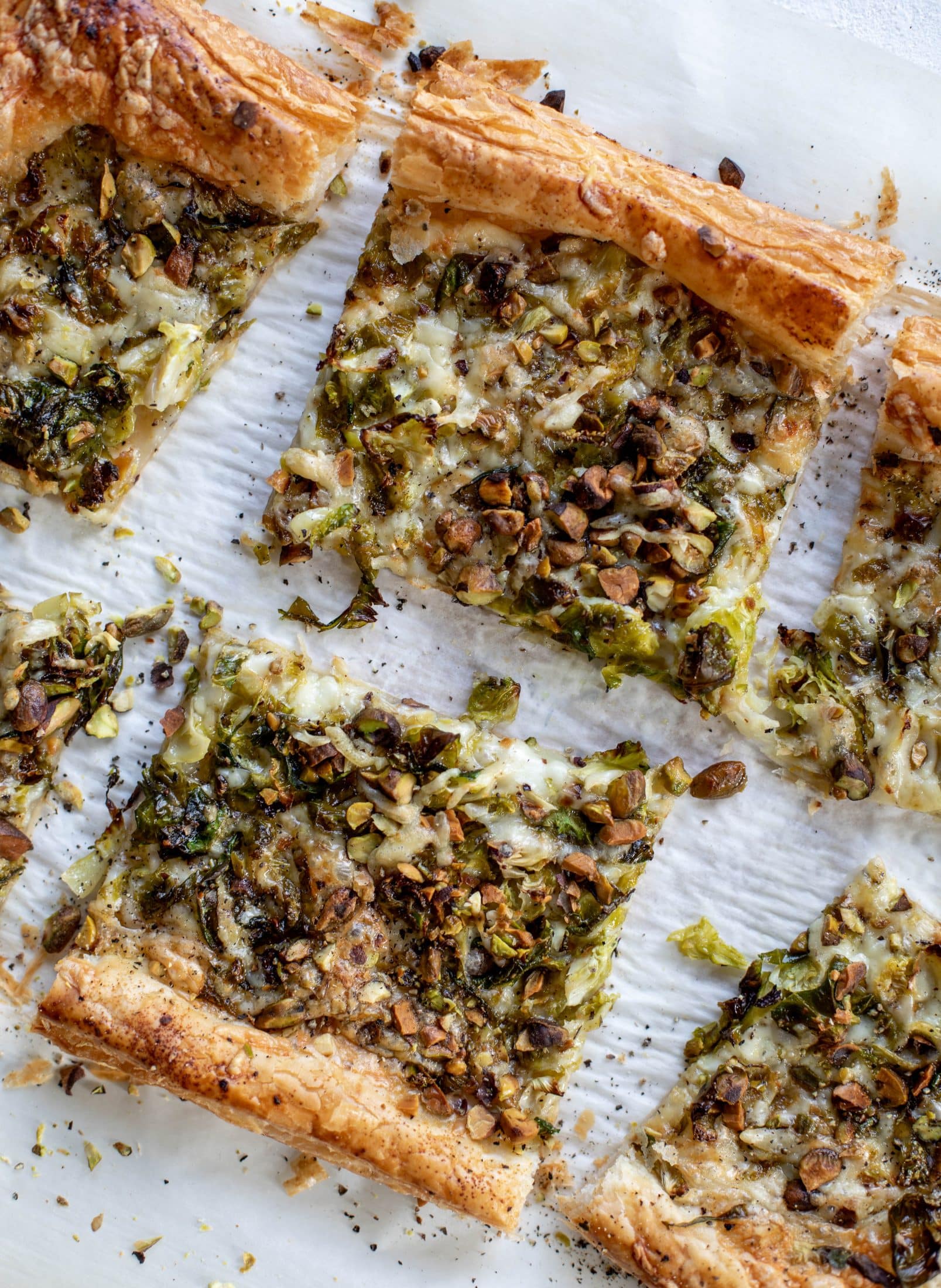 This brussels sprouts tart has a ton of flavor! Melty fontina, sliced brussels and crunchy pistachios all on top of puff pastry. Delish!