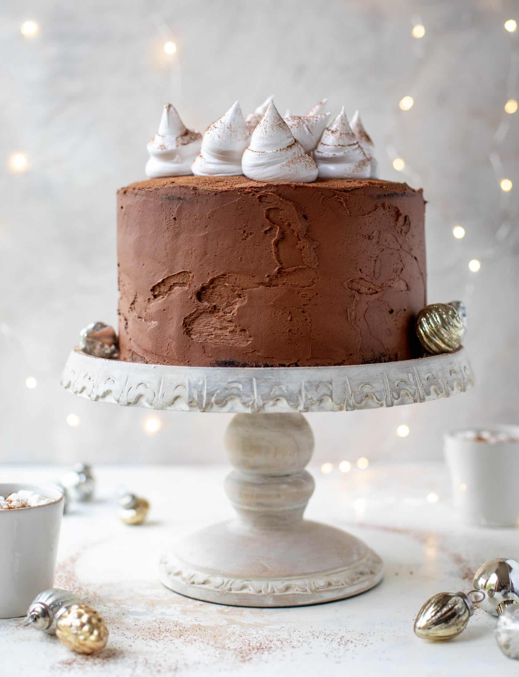 This hot cocoa cake is made with the fudgiest chocolate cake, smothered in chocolate cream cheese frosting and dolloped with whipped marshmallow!