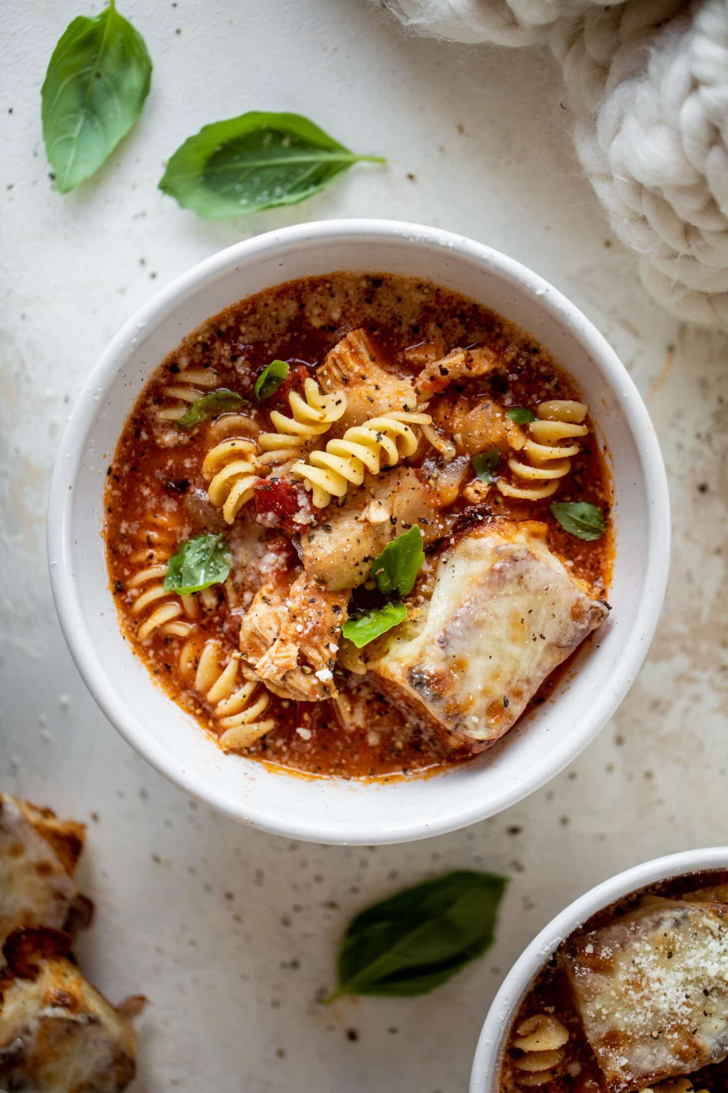 This chicken parmesan soup is ridiculously flavorful and so easy to make! Juicy chicken with pasta, fire roasted tomatoes and mozzarella croutons. Yum! 
