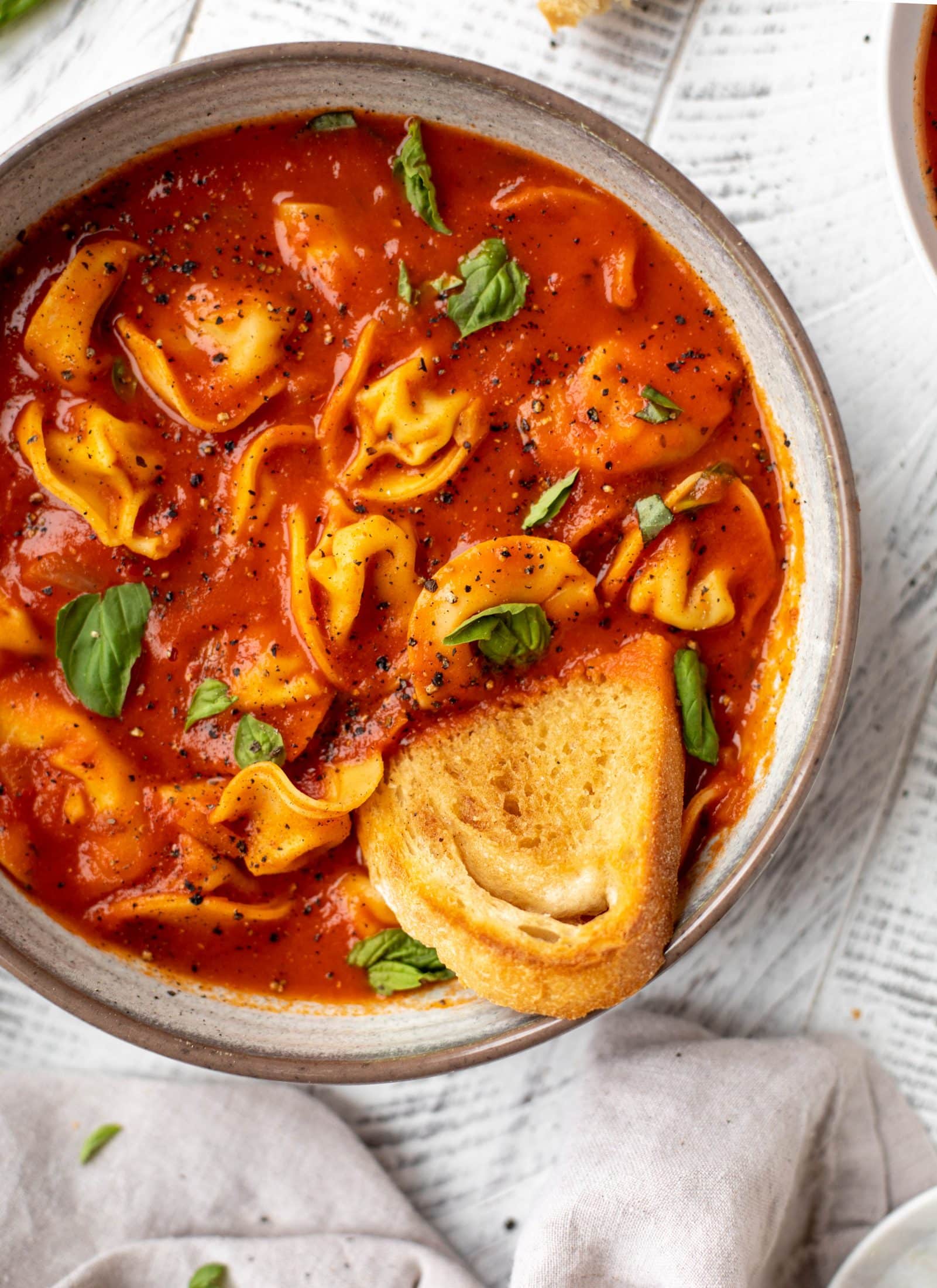 This curried tomato tortellini soup has so much flavor! Serve with cheesy tortellini and brown butter garlic toasts for the perfect weeknight meal.
