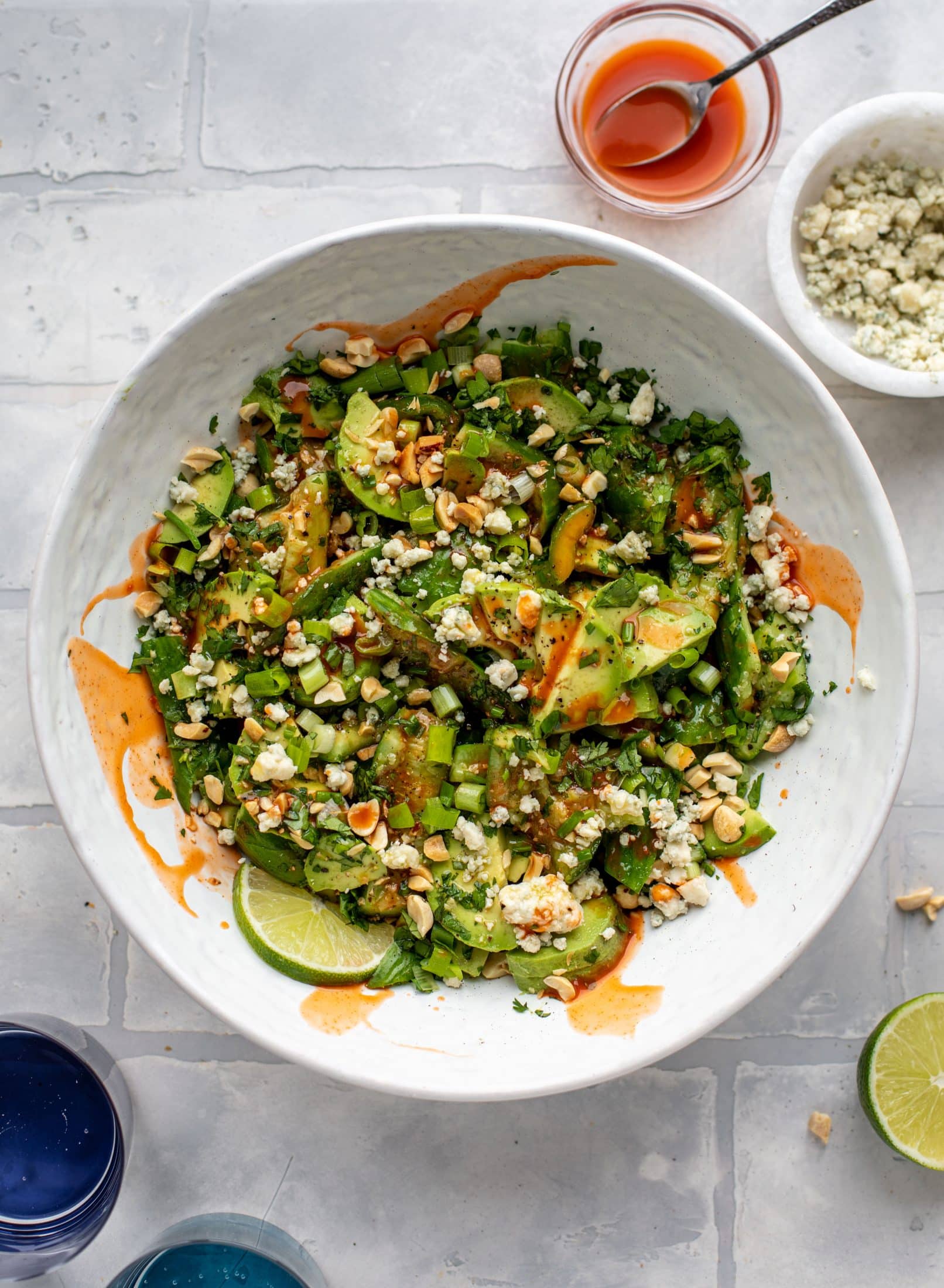This smashed buffalo cucumber salad is filled with tons of buffalo wing flavor! Avocado, blue cheese, peanuts and lime juice make this irresistible. 