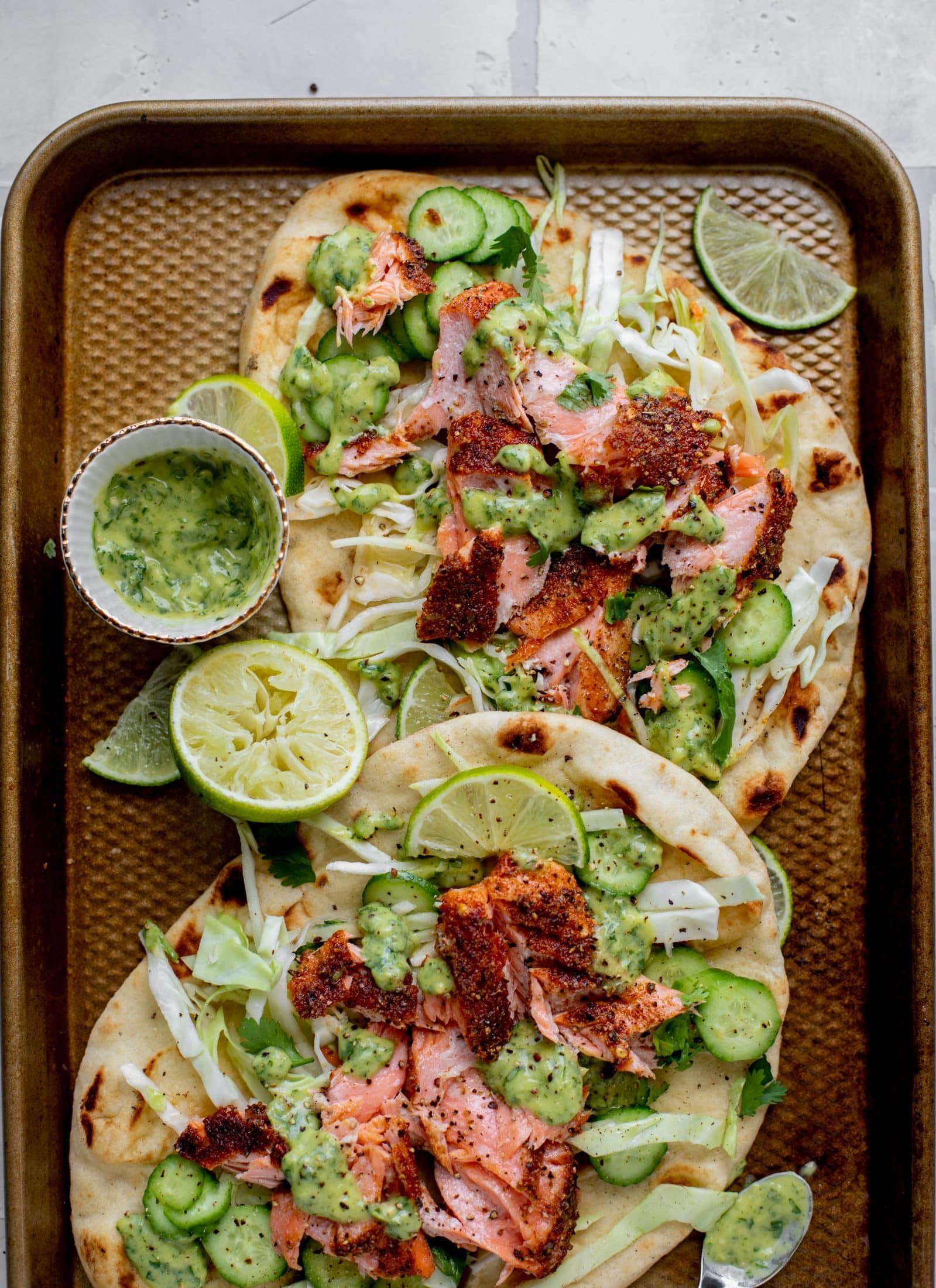 grilled salmon on naan bread with slaw and cilantro sauce