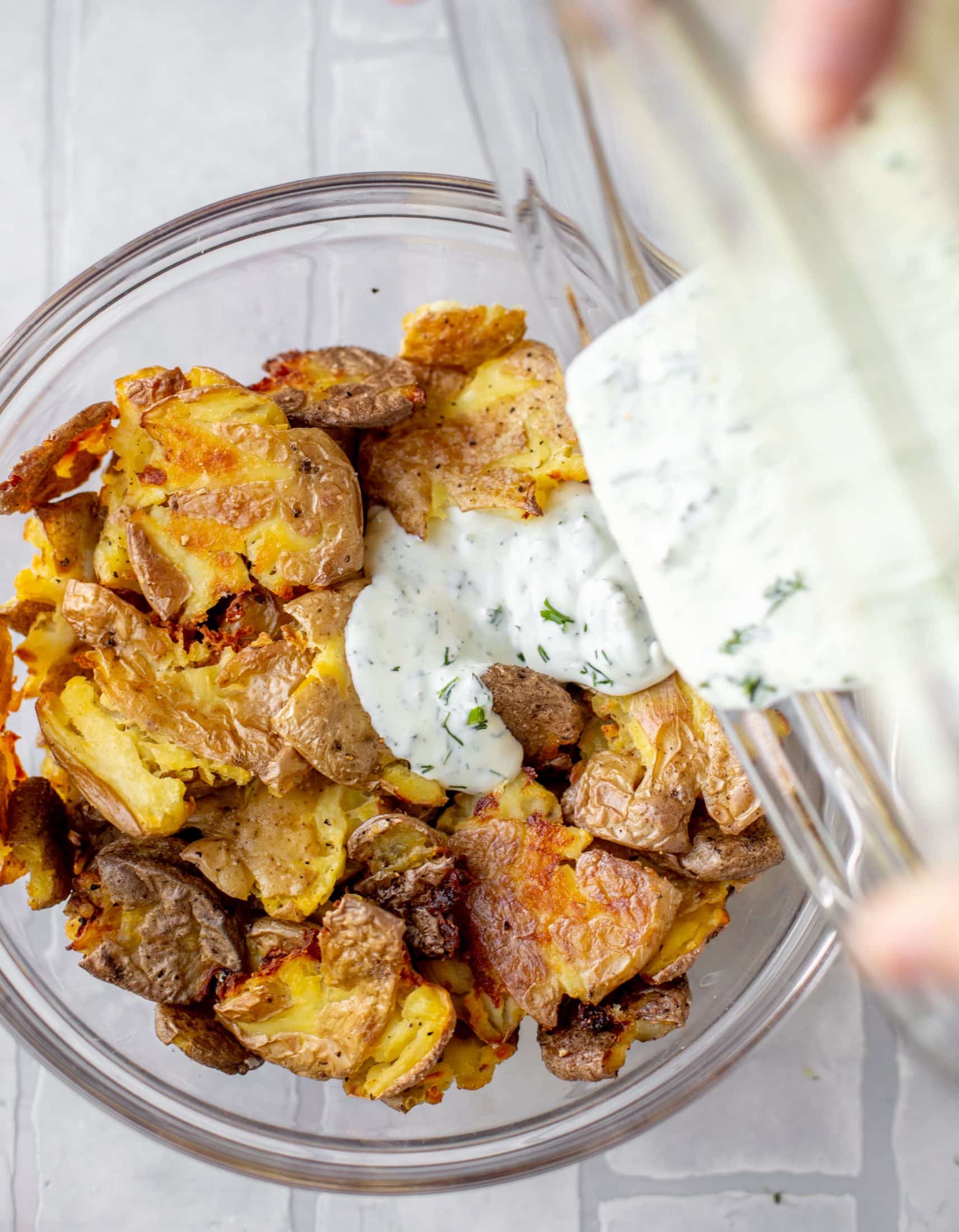 pouring dressed on smashed potatoes