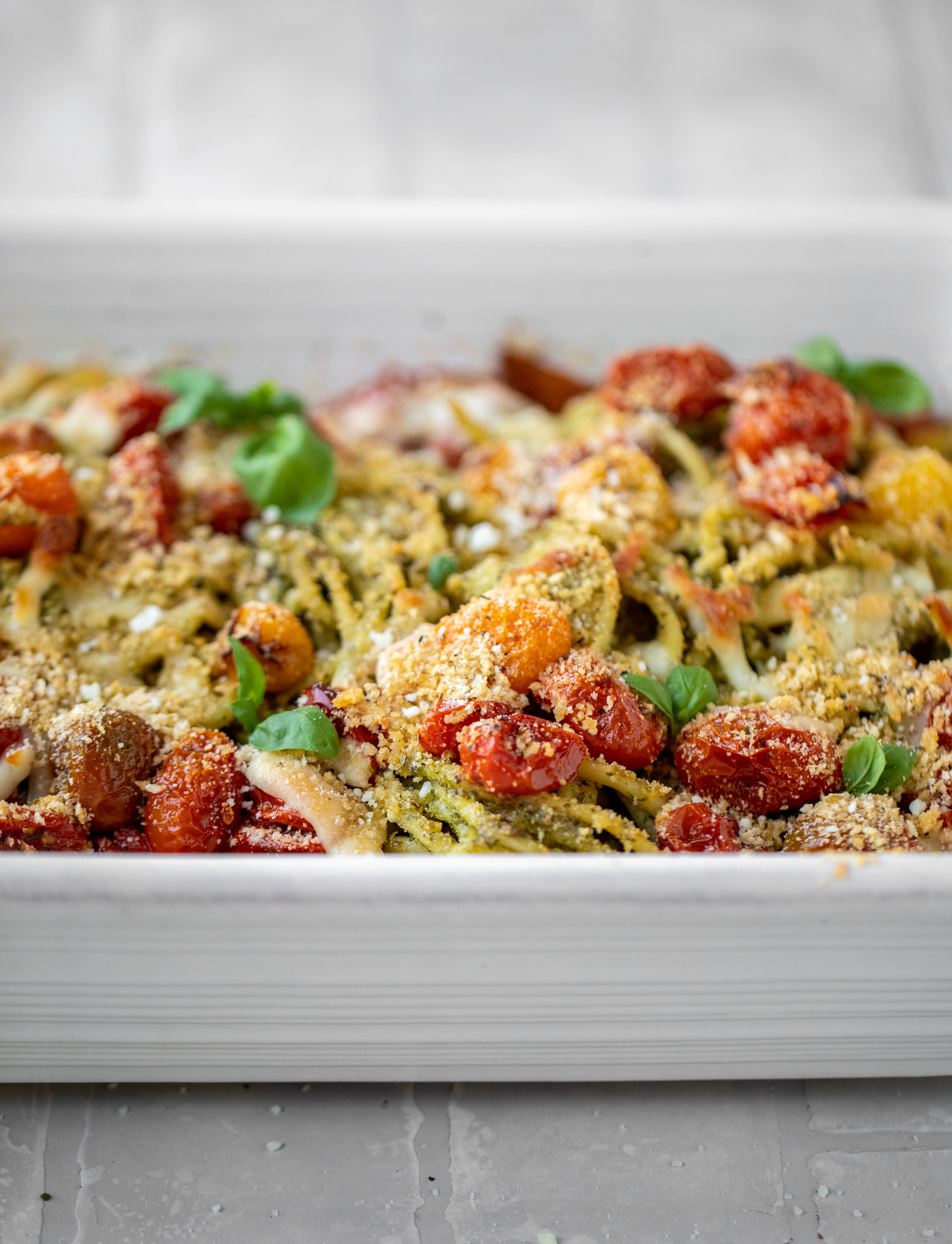 baked pesto bucatini with burst tomatoes