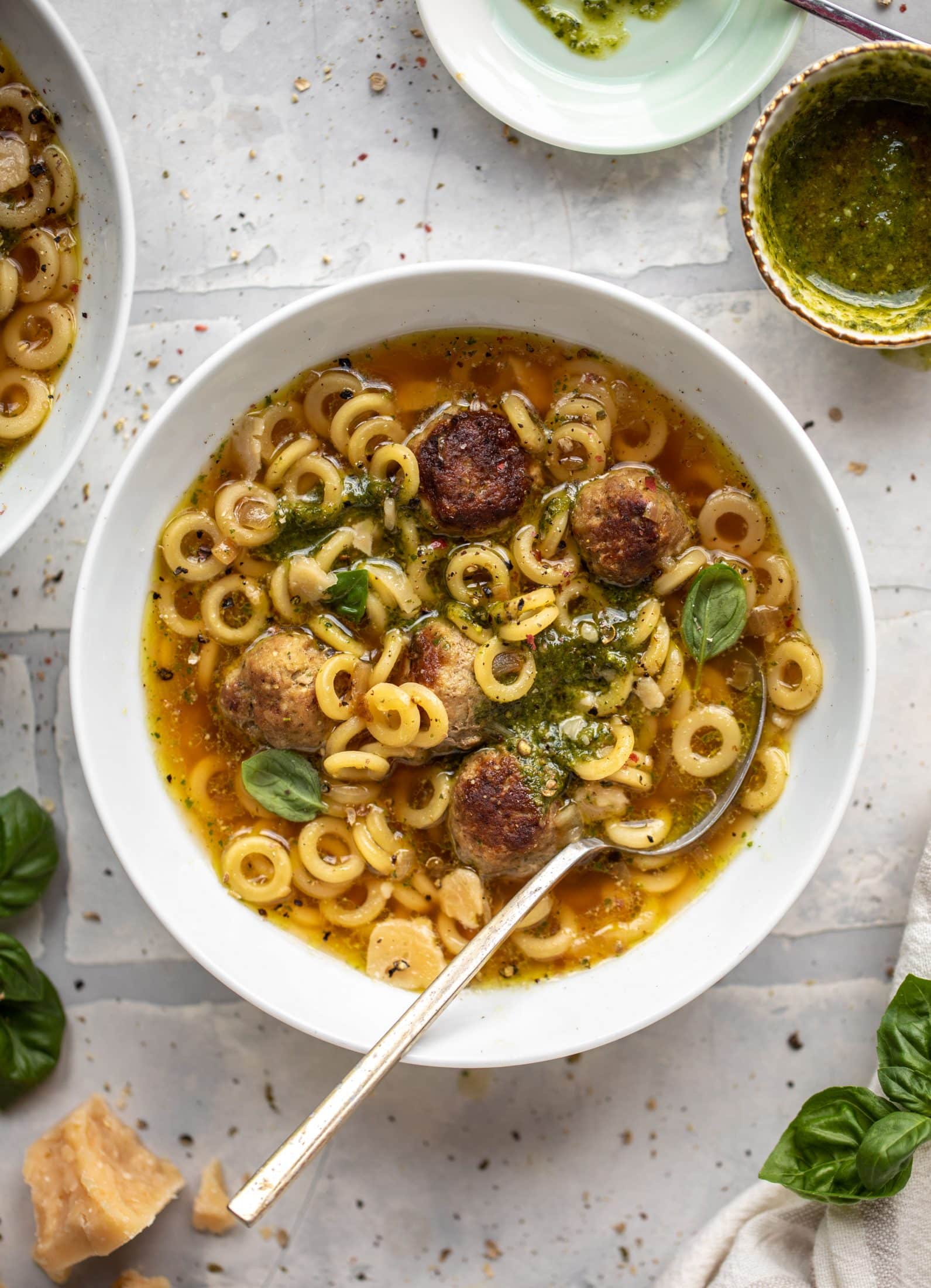 summer pesto mini meatball soup with spoon