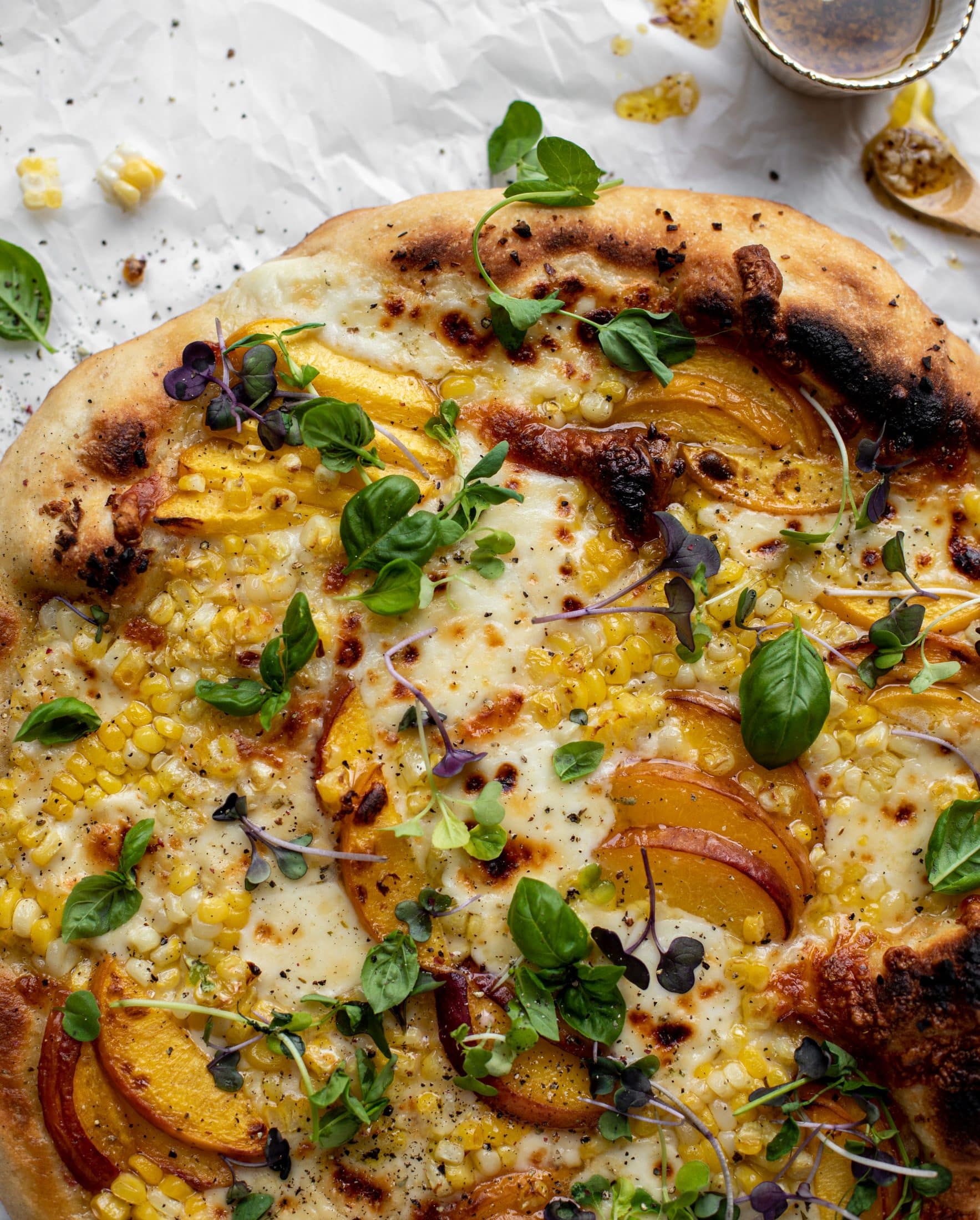 grilled peach pizza with corn and chili garlic oil