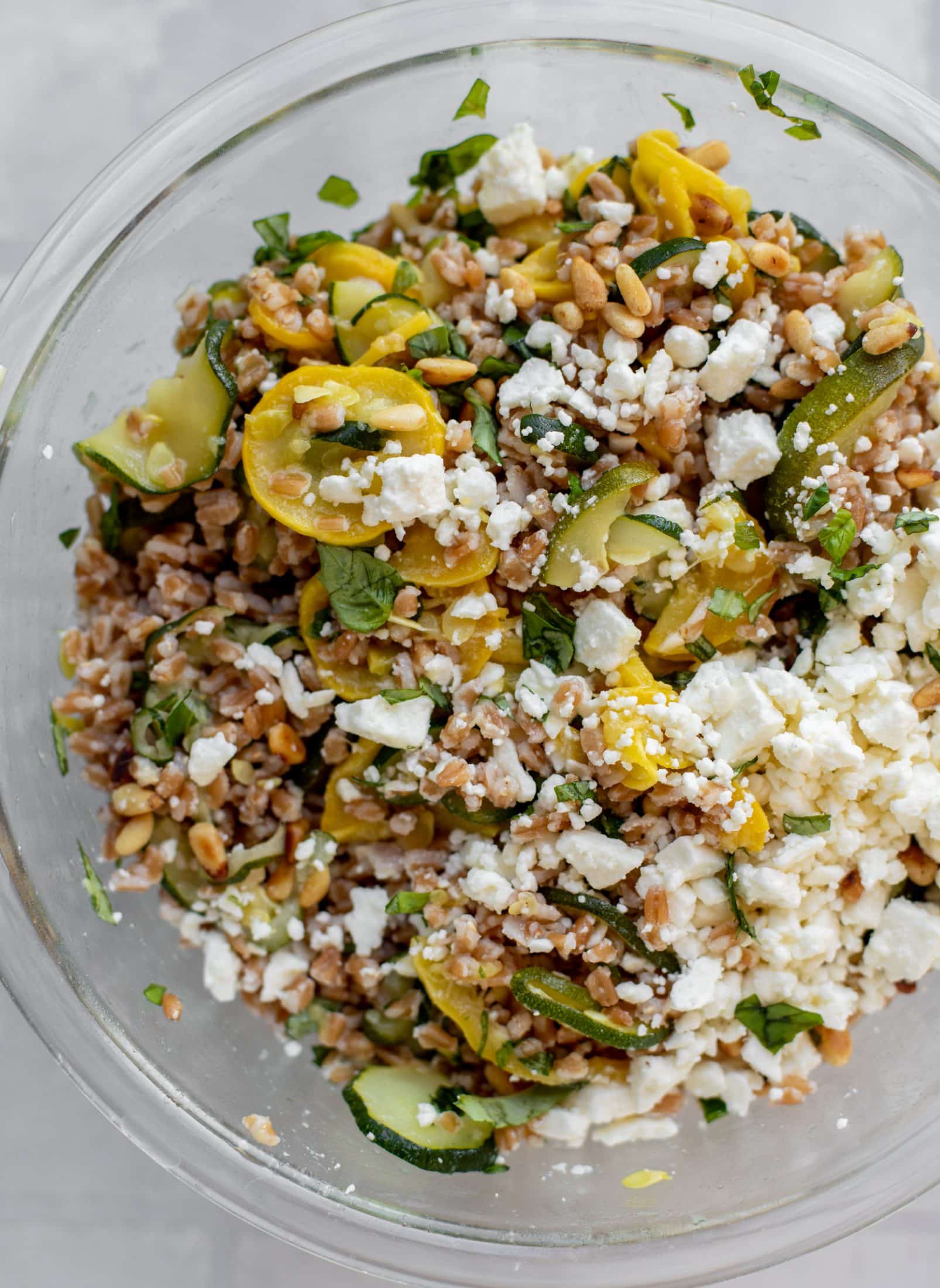 tossing summer squash basil farro salad