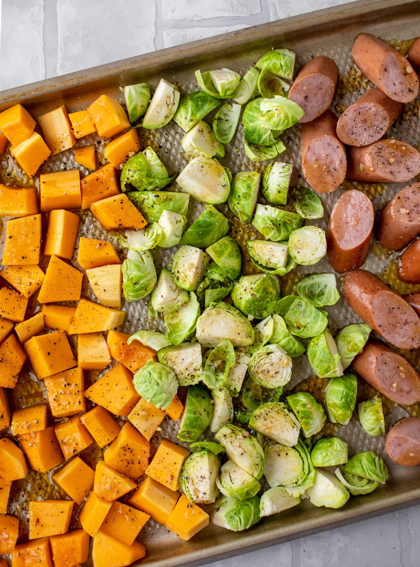 squash, brussels and sausage on the sheet pan