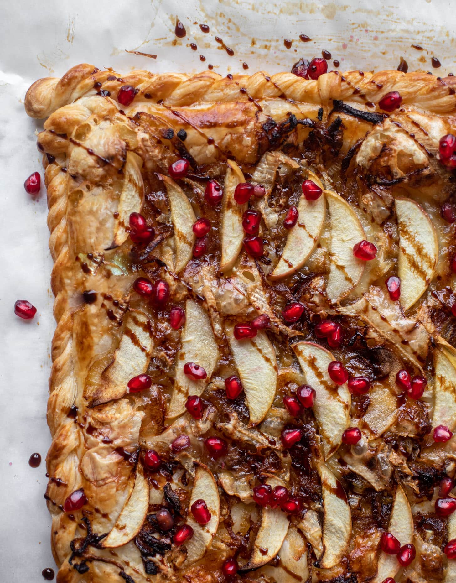 caramelized onion, apple and brie puff pastry tart with pomegranate molasses