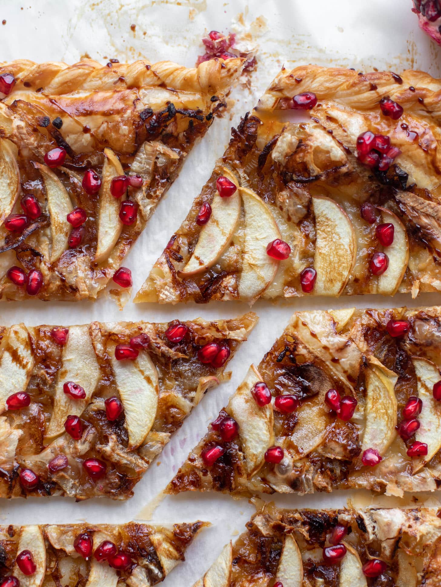 caramelized onion, apple and brie puff pastry tart with pomegranate molasses