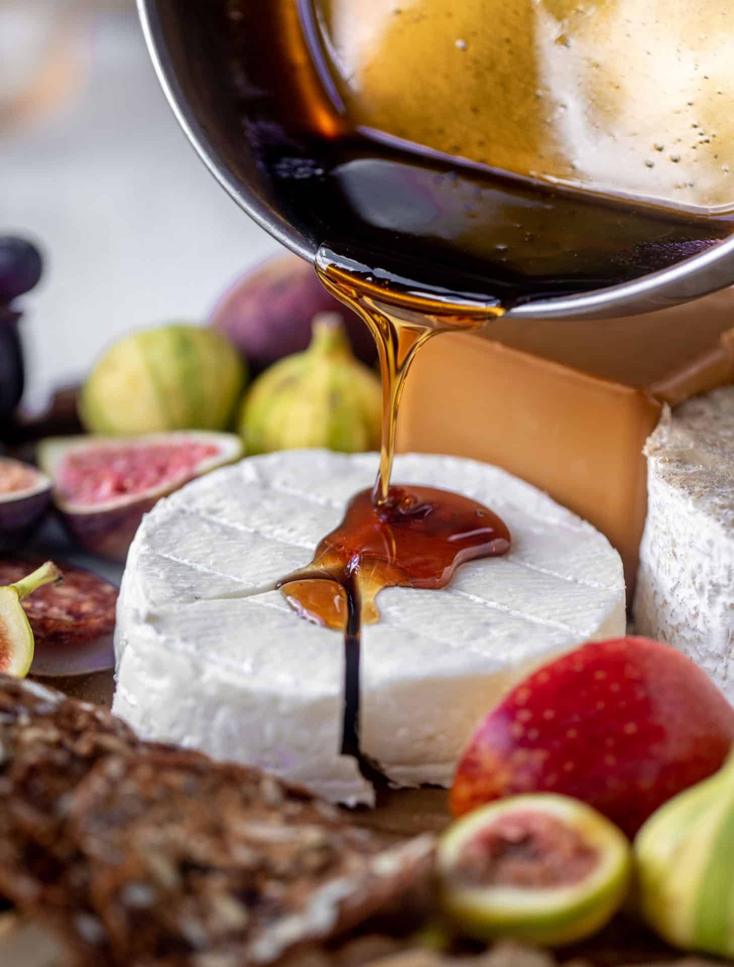 pouring bourbon crackling caramel on cheese