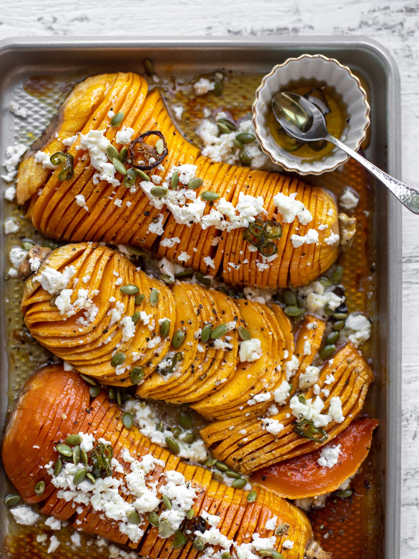 hot honey hasselback butternut squash with feta and pepitas