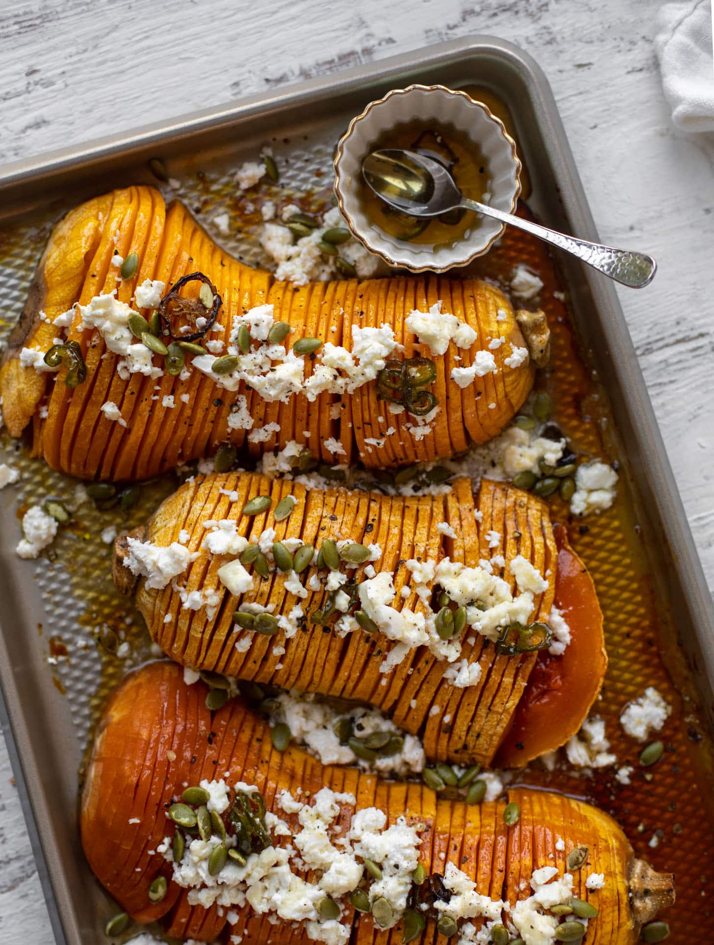hot honey hasselback butternut squash with feta and pepitas